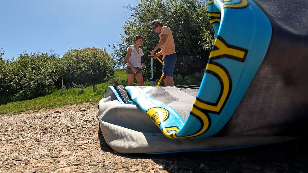 Logan Gasparac (right) and Zoe Ranaldi (left) inflate a paddle board at Causey Reservoir.