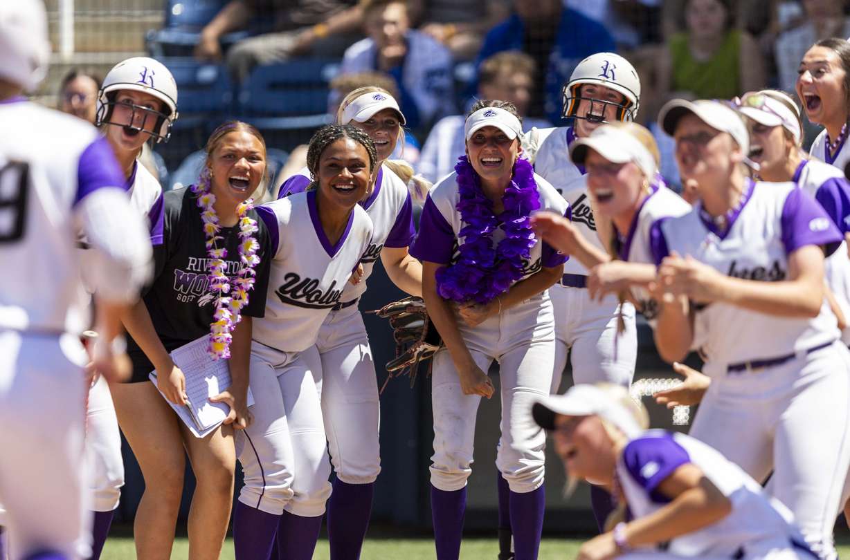 Riverton’s Maggie Hamblin (19) is welcomed at home plate by celebrating teammates after hitting a home run during Game 2 of the 6A softball state championship series against Bingham at Miller Park Complex at BYU in Provo on Friday, May 23, 2025.