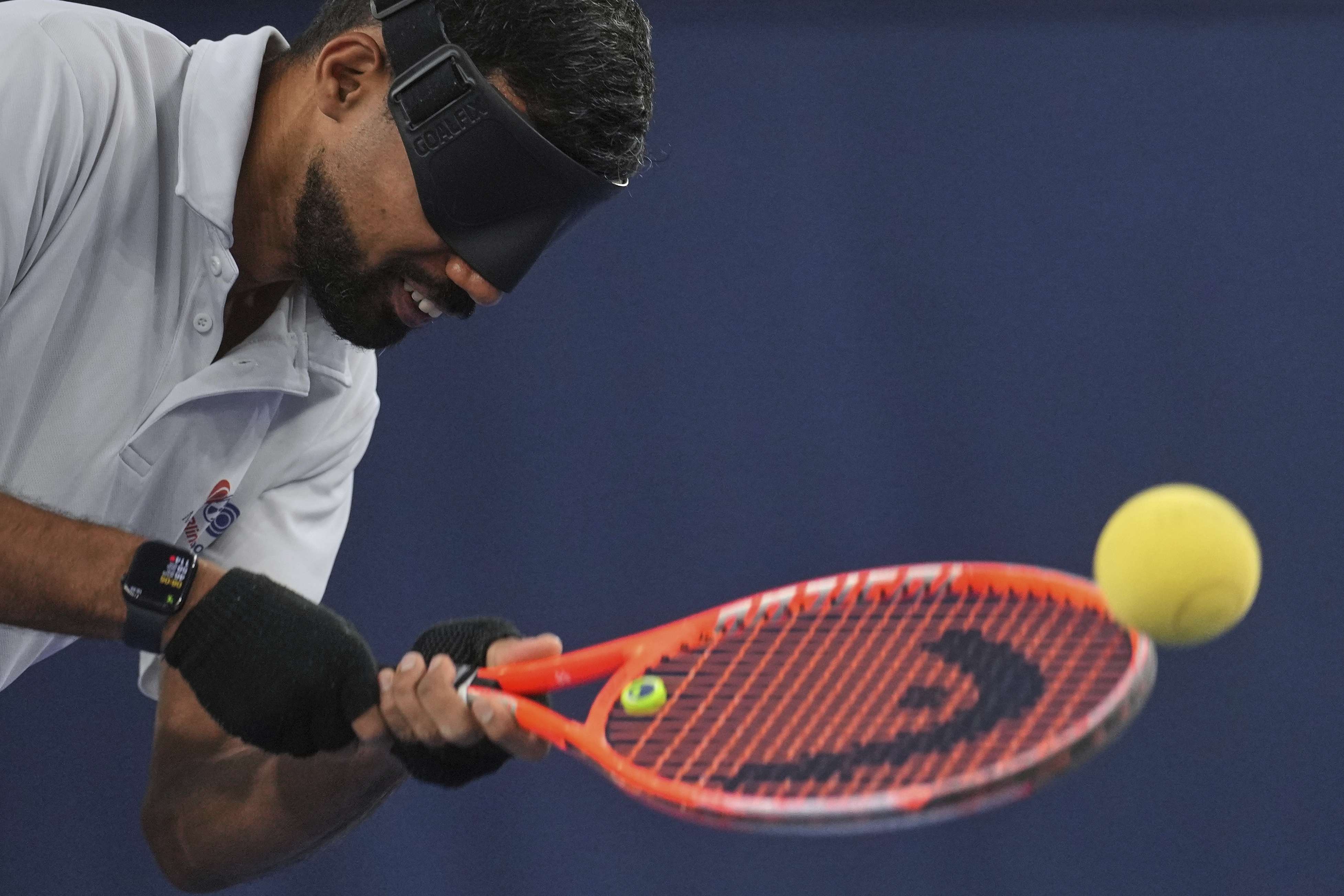 Blind tennis champion Naqi Rizvi plays a shot during a visually impaired tennis training session in London, Tuesday, May 20, 2025.