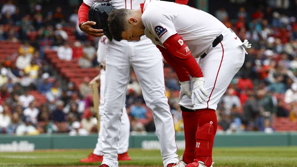 Boston Red Sox's Alex Bregman bends over before leaving the game after injuring himself on a single against the Baltimore Orioles during the fifth inning in the first baseball game of a doubleheader Friday, May 23, 2025, at Fenway Park in Boston.
