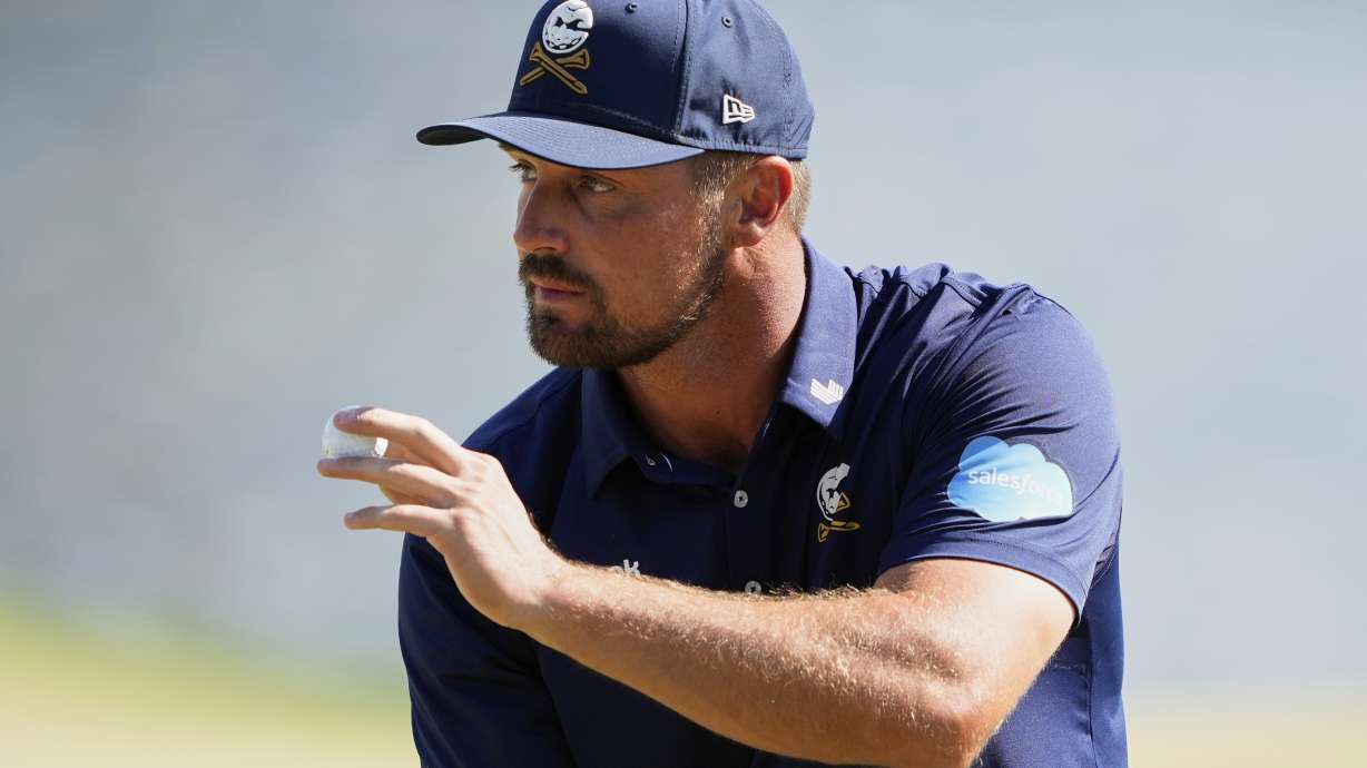 Bryson DeChambeau waves after making a putt on the 14th hole during the final round of the PGA Championship golf tournament at the Quail Hollow Club, Sunday, May 18, 2025, in Charlotte, N.C.
