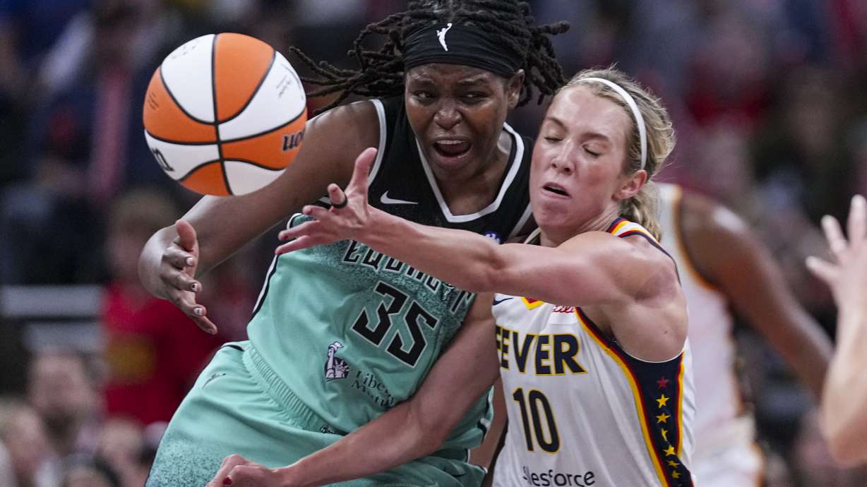New York Liberty center Jonquel Jones (35) and Indiana Fever guard Lexie Hull (10) go for a loose ball in the second half of a WNBA basketball game in Indianapolis, Saturday, May 24, 2025.