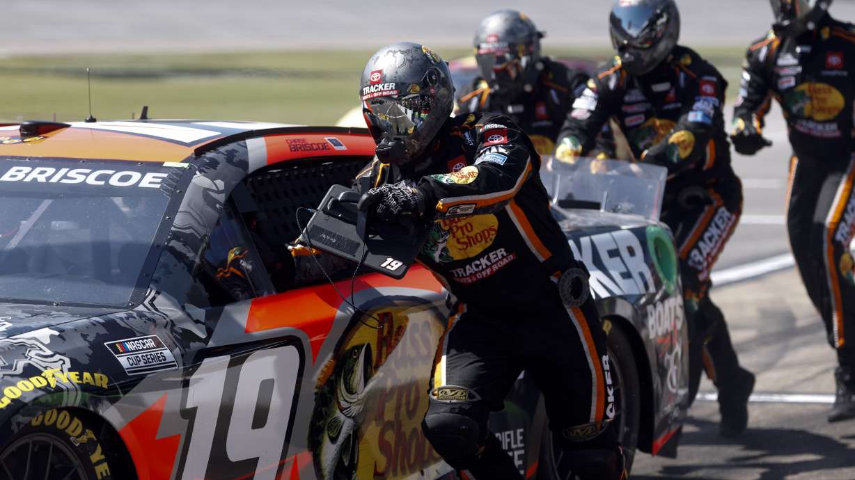 Crew members of Chase Briscoe push his car to get it started after a pit stop during a NASCAR Cup Series auto race at Talladega Superspeedway, Sunday, April 27, 2025, in Talladega, Ala.