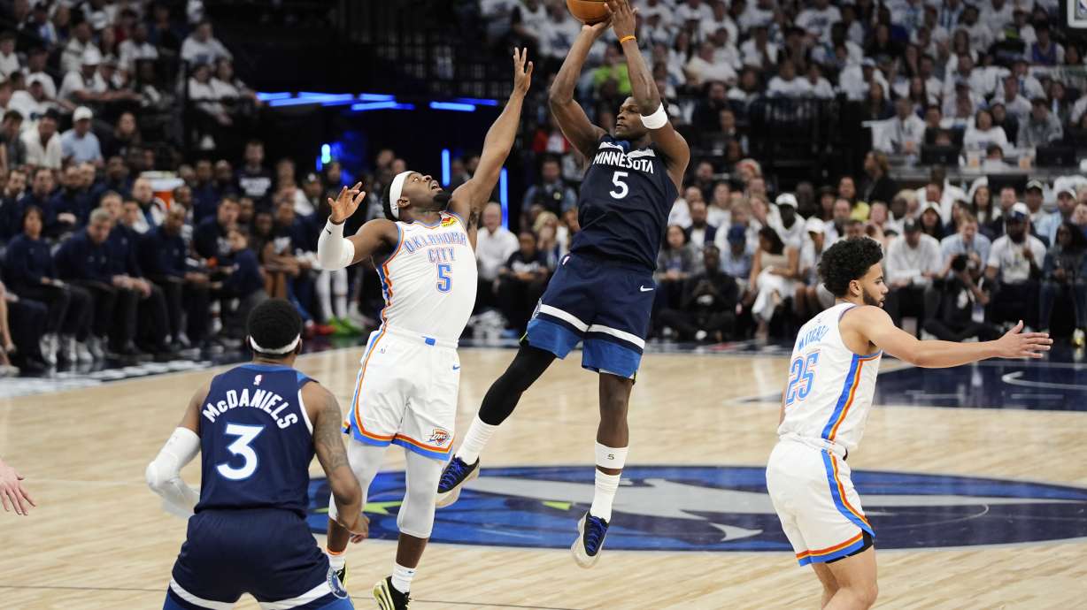 Minnesota Timberwolves guard Anthony Edwards, center right, shoots against Oklahoma City Thunder guard Luguentz Dort, center left, during the first half of Game 3 of the Western Conference finals of the NBA basketball playoffs, Saturday, May 24, 2025, in Minneapolis.