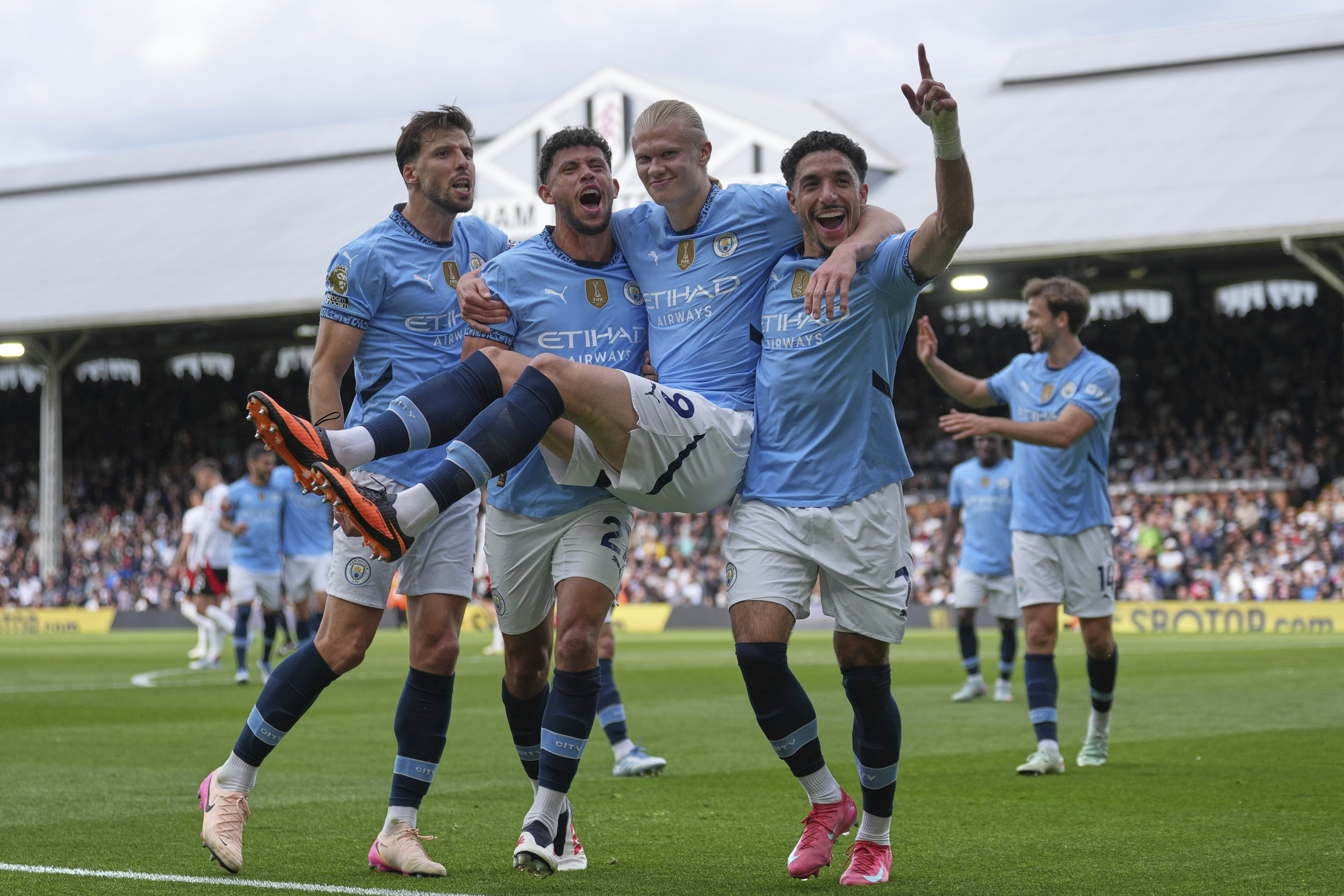 Manchester City players celebrate after Manchester City's Erling Haaland, centre, scored his side's second goal during the English Premier League soccer match between Fulham and Manchester City at Craven Cottage, London, Sunday, May 25, 2025. 