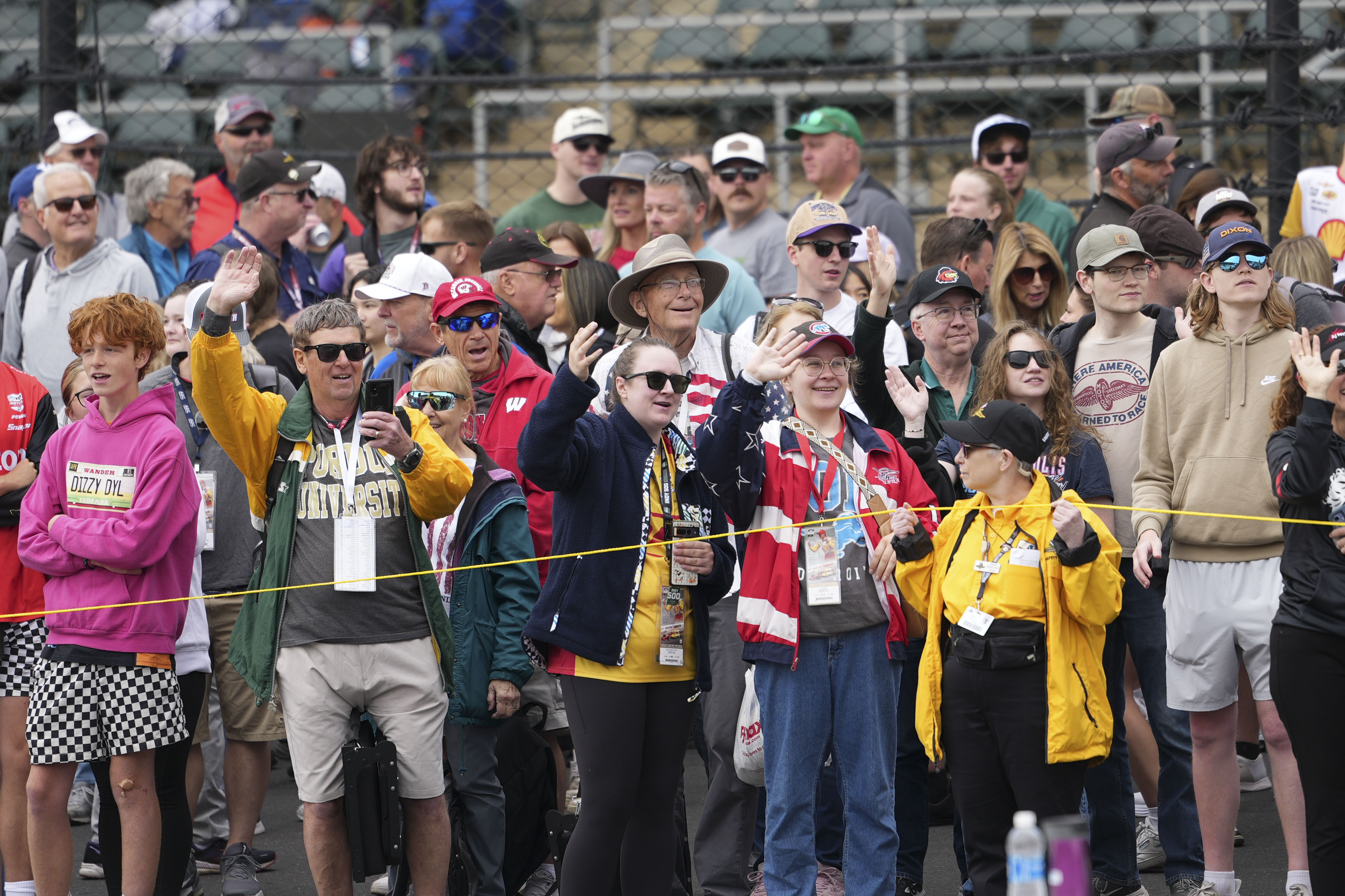 Fans waive during parade laps before the start of the Indianapolis 500 auto race at Indianapolis Motor Speedway in Indianapolis, Sunday, May 25, 2025. 