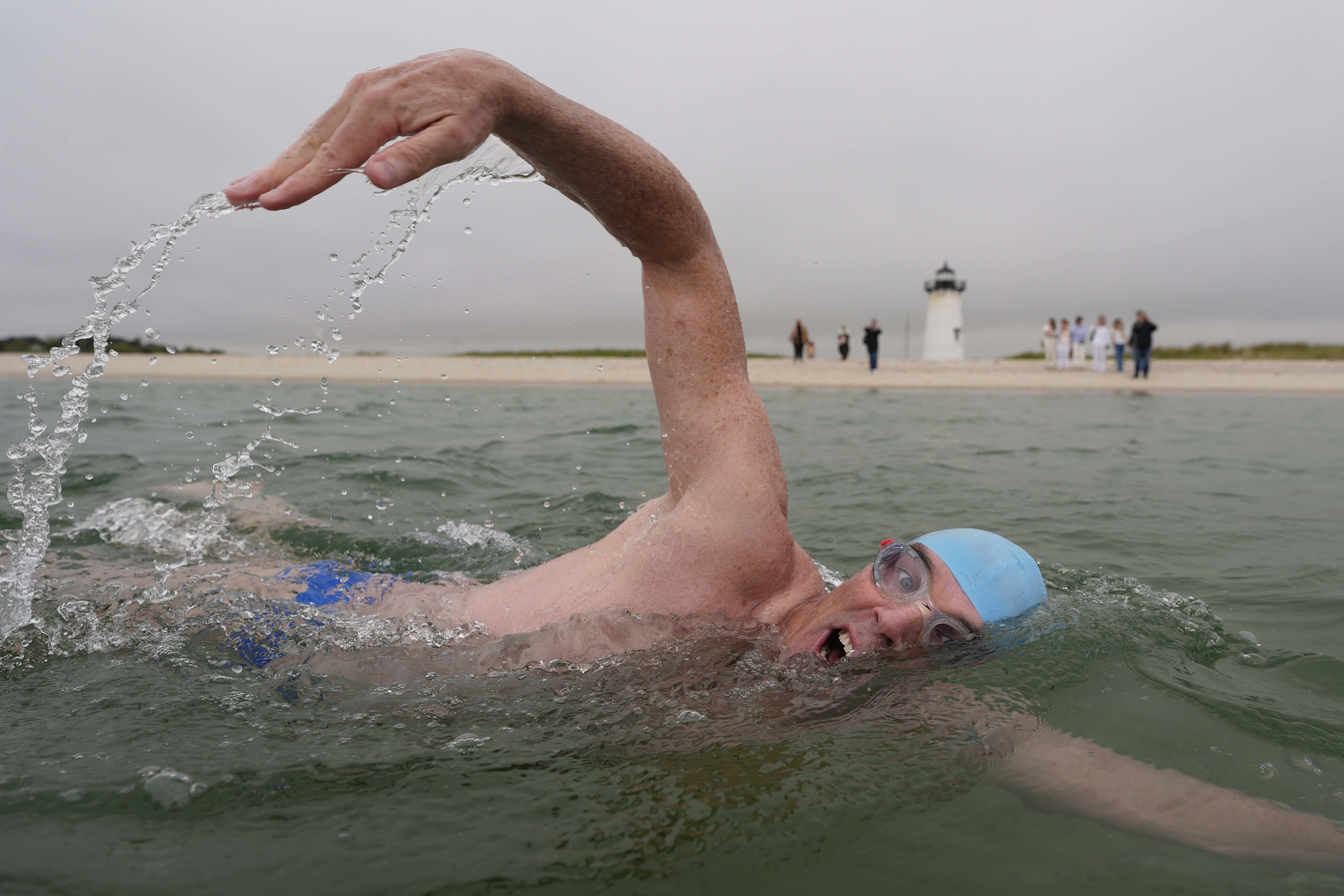 Endurance swimmer Lewis Pugh swims near the Edgartown Harbor Light, Thursday, May 15, 2025, in Edgartown, Mass. 