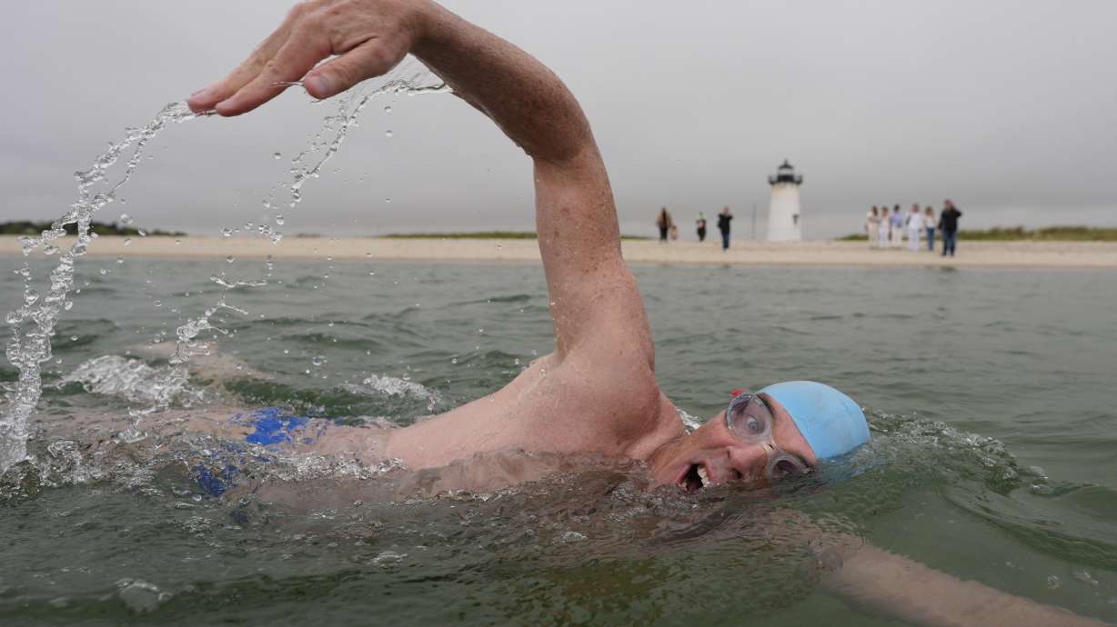 Endurance swimmer Lewis Pugh swims near the Edgartown Harbor Light, Thursday, May 15, 2025, in Edgartown, Mass.
