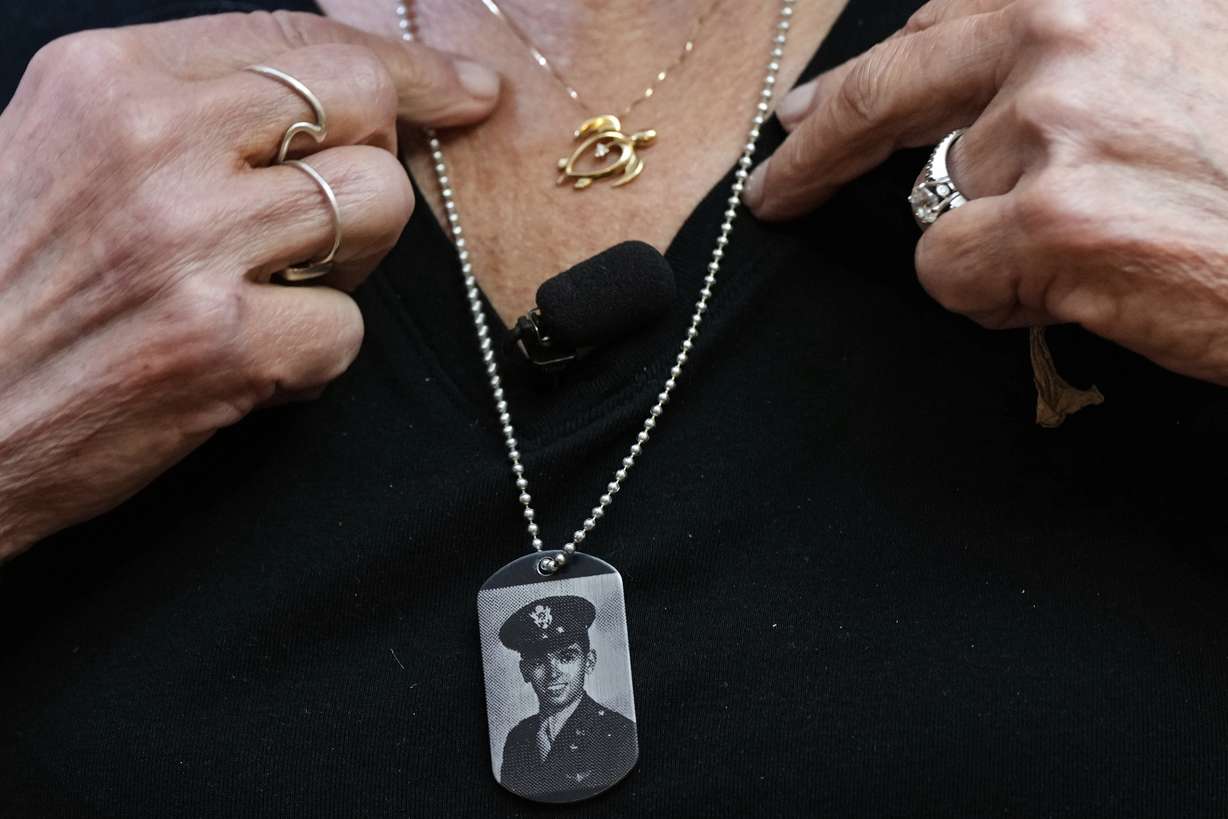 Diane Christie wears a necklace with a photograph of her uncle, World War II U.S. Army Air Forces 2nd Lt. Thomas Kelly, inside Santos Robinson Mortuary in San Leandro, Calif., on Friday. Kelly's remains had been missing since being killed when the World War II bomber nicknamed Heaven Can Wait was hit by anti-aircraft fire and crashed into the water off the coast of New Guinea on March 11, 1944.