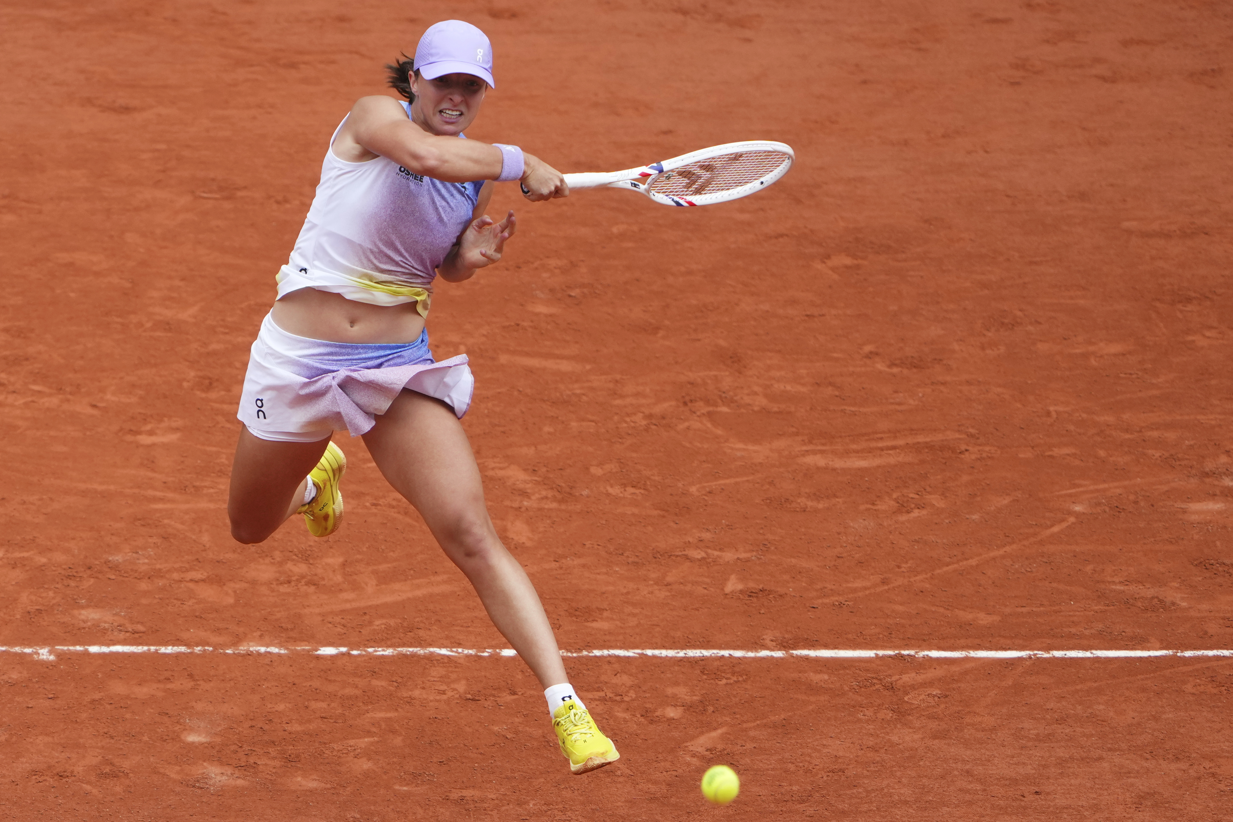 Poland's Iga Swiatek hits a forehand against Slovakia's Rebecca Sramkova during their first round match of the French Tennis Open, at the Roland-Garros stadium, in Paris, Monday, May 26, 2025.