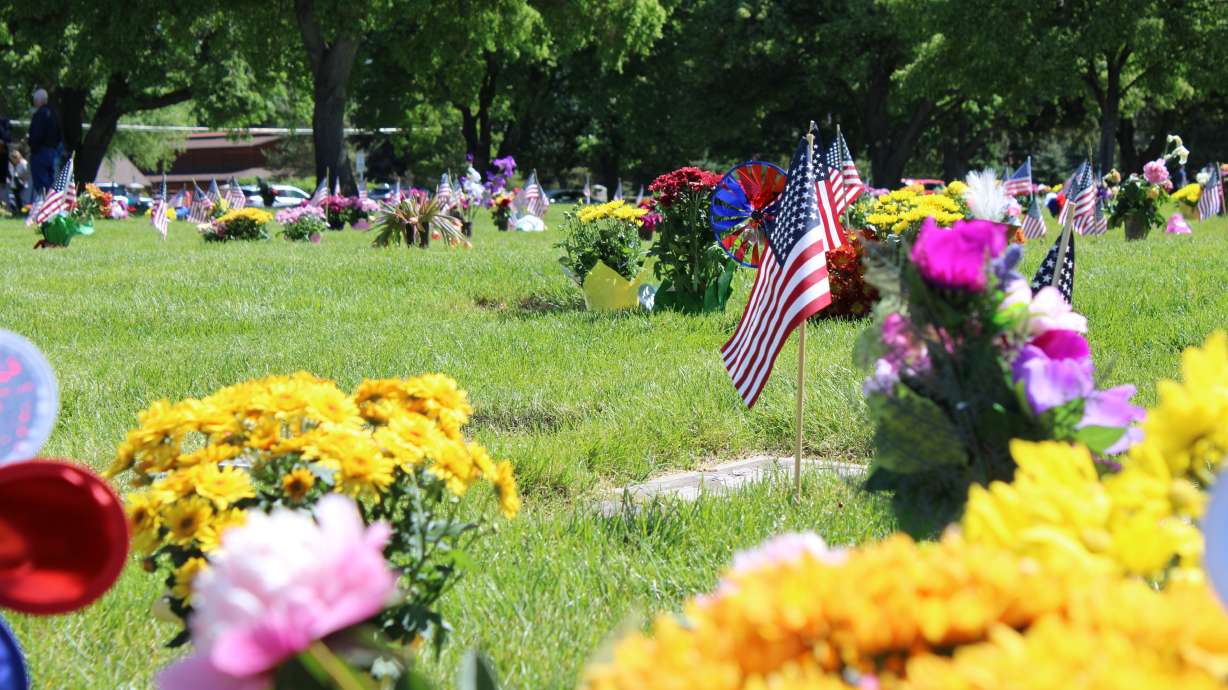 Decorated headstones are seen at Larkin Sunset Gardens in Sandy on Monday.