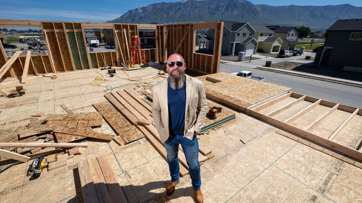 Jed Nilson, a land developer, poses for photos while showing one of his starter homes in Plain City on Thursday.