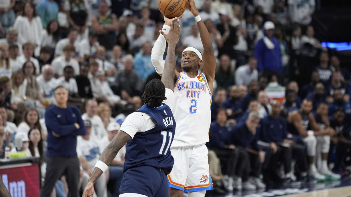 Oklahoma City Thunder guard Shai Gilgeous-Alexander (2) shoots against Minnesota Timberwolves center Naz Reid during the second half of Game 4 of the Western Conference finals of the NBA basketball playoffs Monday, May 26, 2025, in Minneapolis.