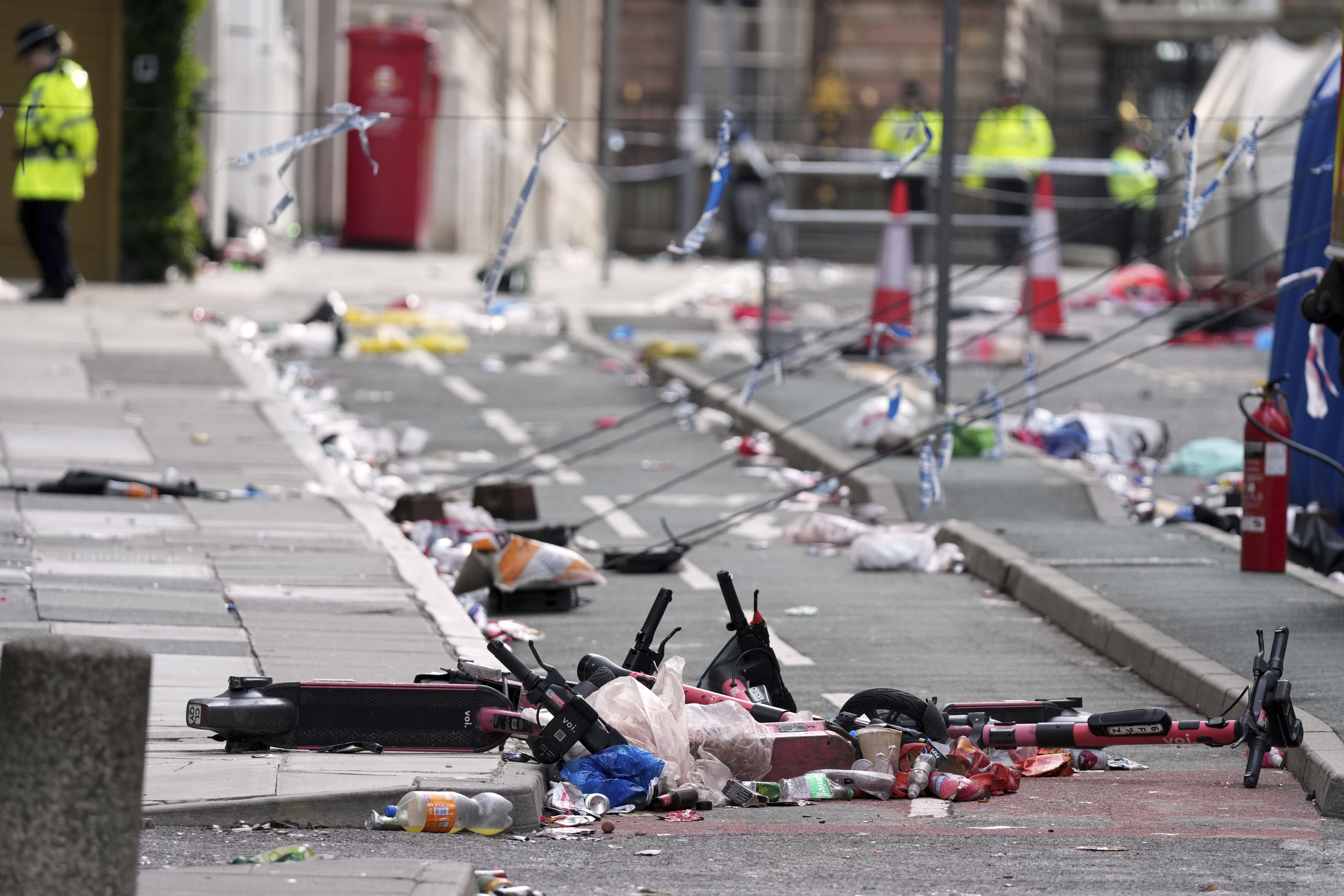 Scooters lie on the site where a 53-year-old British man plowed a minivan into a crowd of Liverpool soccer fans who were celebrating the city's Premier League championship Monday, injuring more than 45 people in Liverpool, England, Tuesday, May 27, 2025.