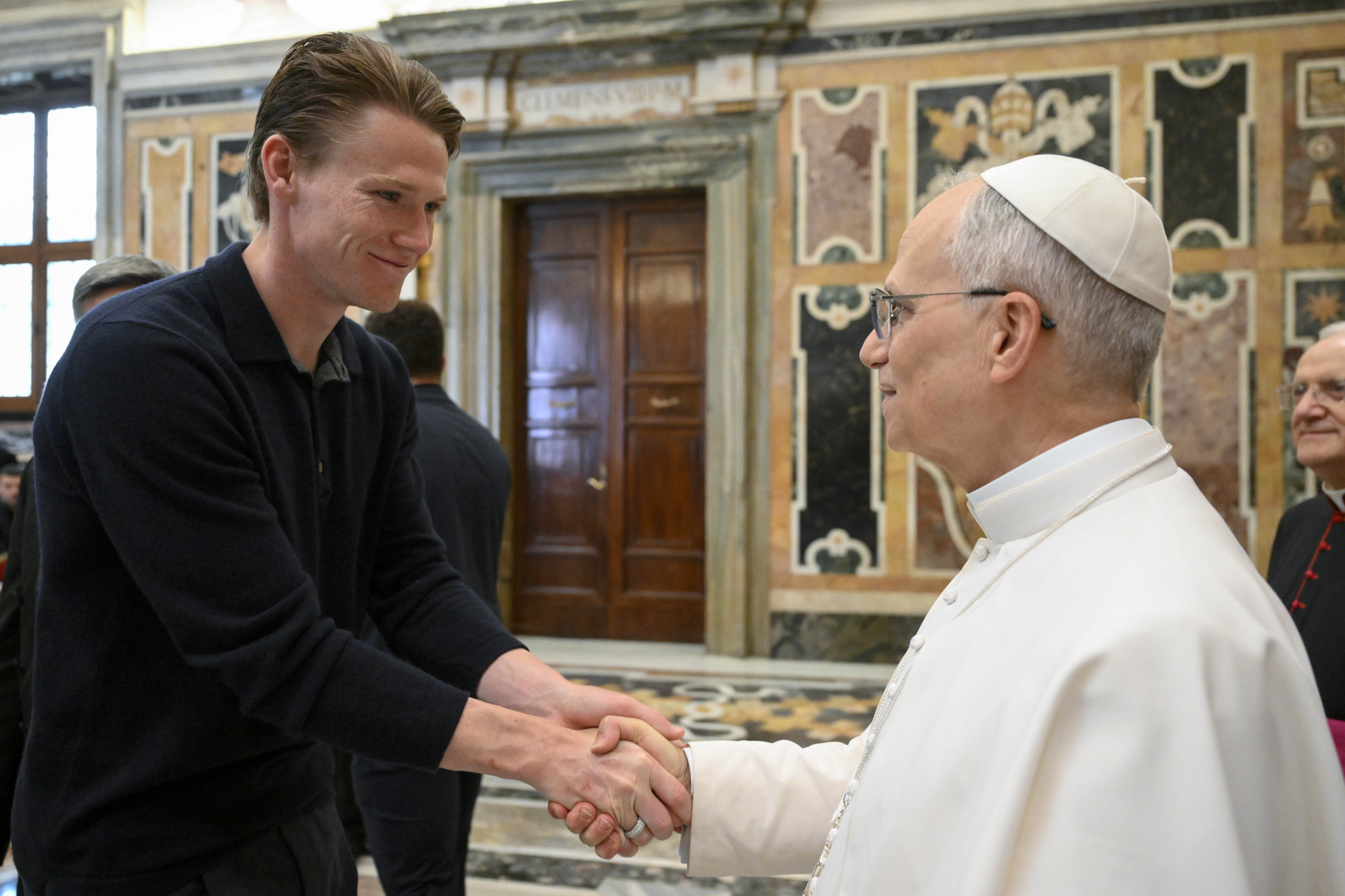 Napoli soccer team's midfielder Scott McTominay, left, shakes hands with Pope Leo XIV during a papal private audience with the team in the Clementine Hall at the Vatican, Tuesday, May 27, 2025. 