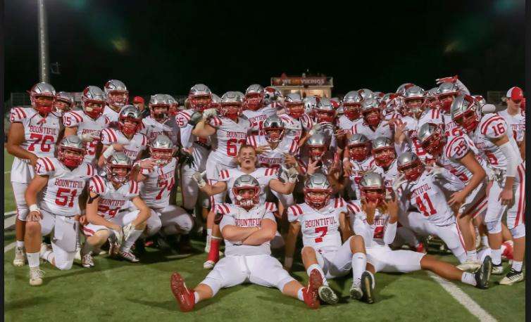 Roman Groves, center, poses with his Bountiful High School football team.