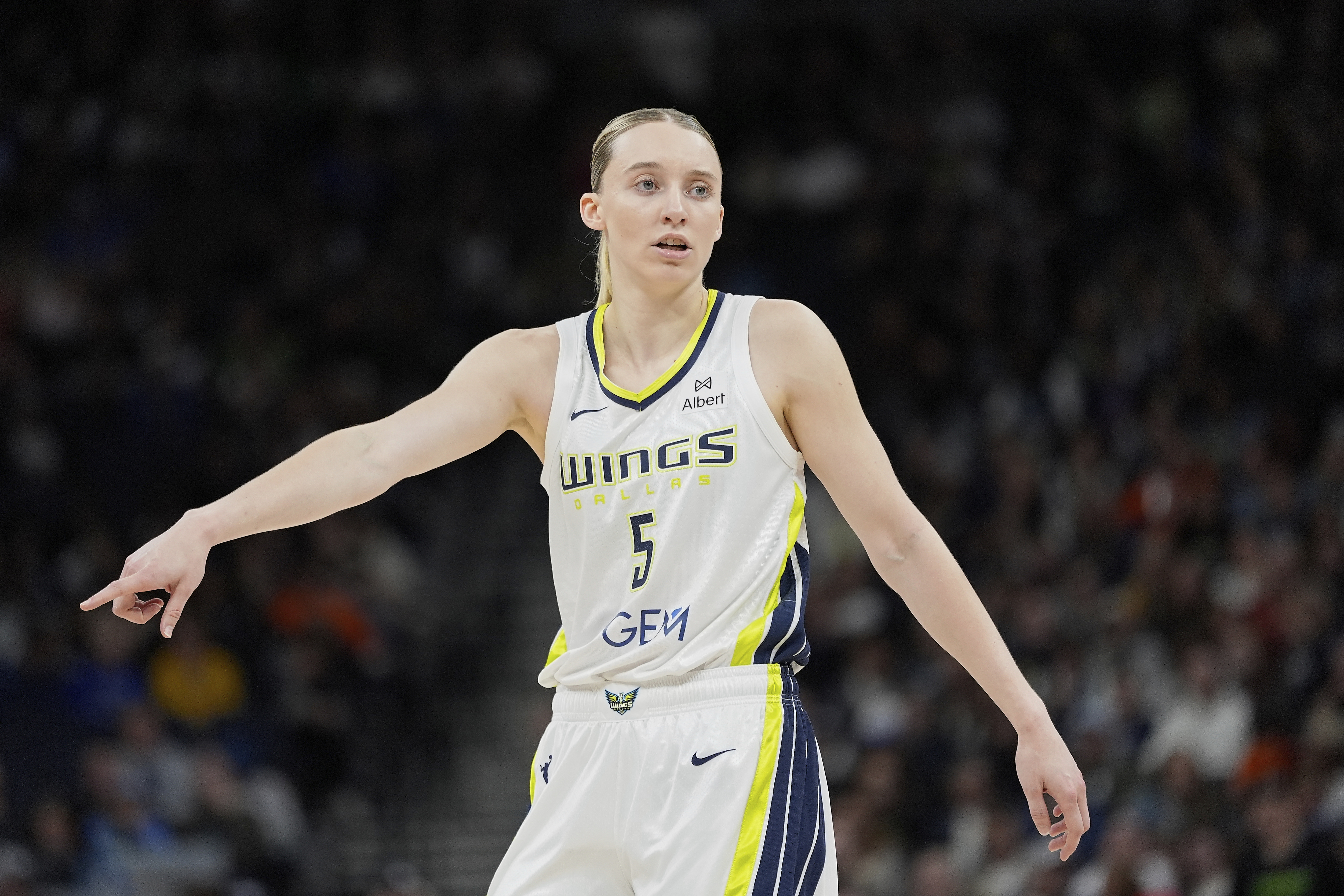 Dallas Wings guard Paige Bueckers (5) points during the first half of a WNBA basketball game against the Minnesota Lynx, Wednesday, May 21, 2025, in Minneapolis. 