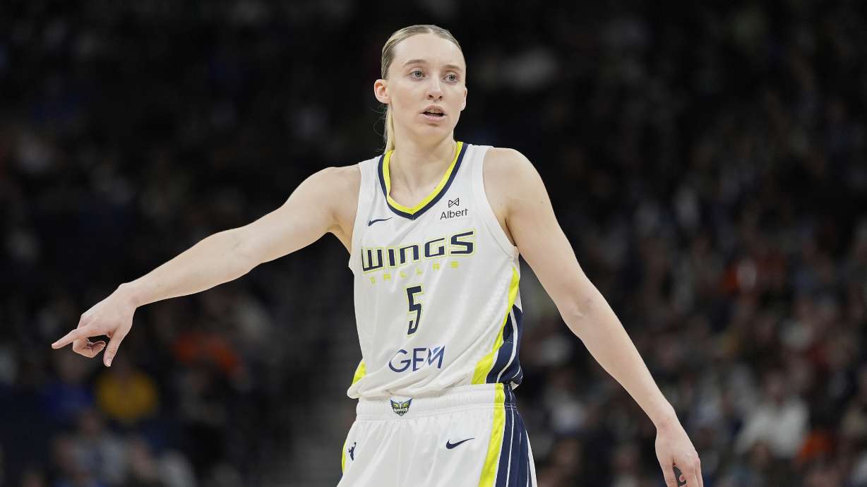 Dallas Wings guard Paige Bueckers (5) points during the first half of a WNBA basketball game against the Minnesota Lynx, Wednesday, May 21, 2025, in Minneapolis.