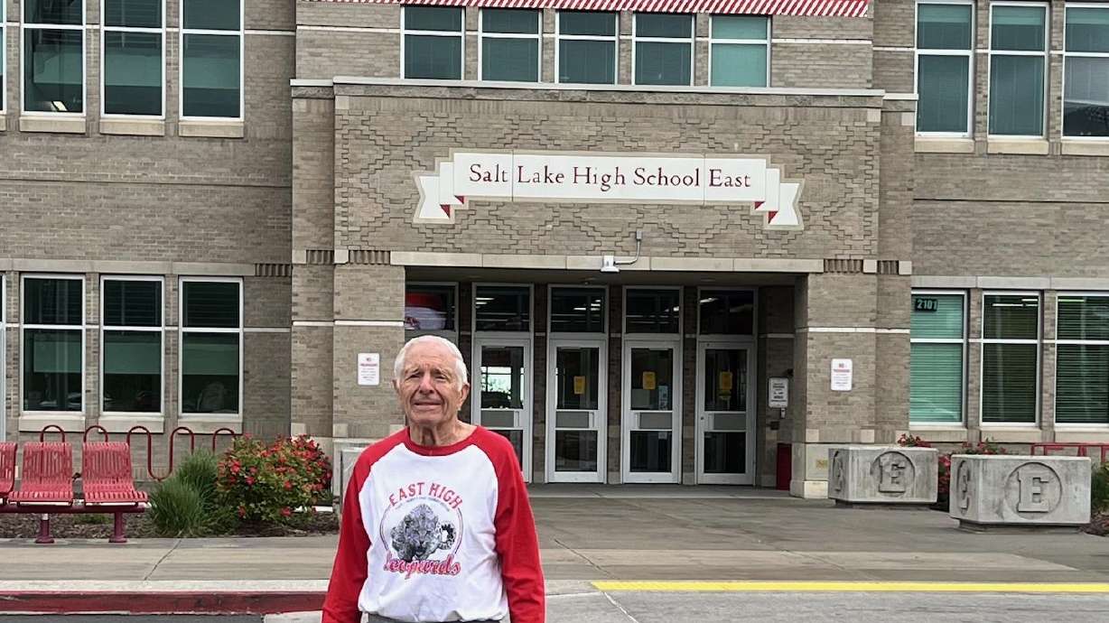 Thomas Hagerman, 85, stands in front of his alma mater, East High School, where he's been substitute teaching for the last 15 years.