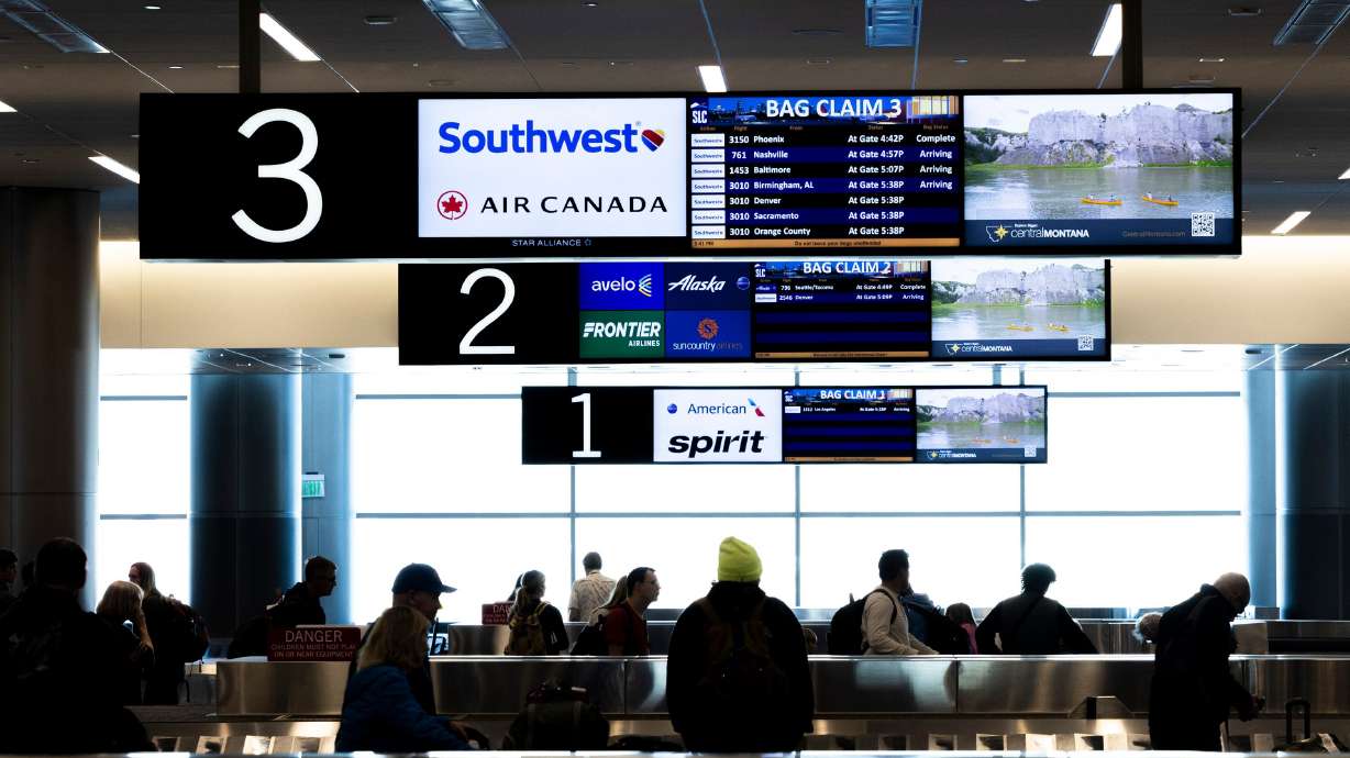 Passengers retrieve their bags at the Salt Lake City International Airport on March 23. Tuesday is the last day to get free checked bags on Southwest Airlines.