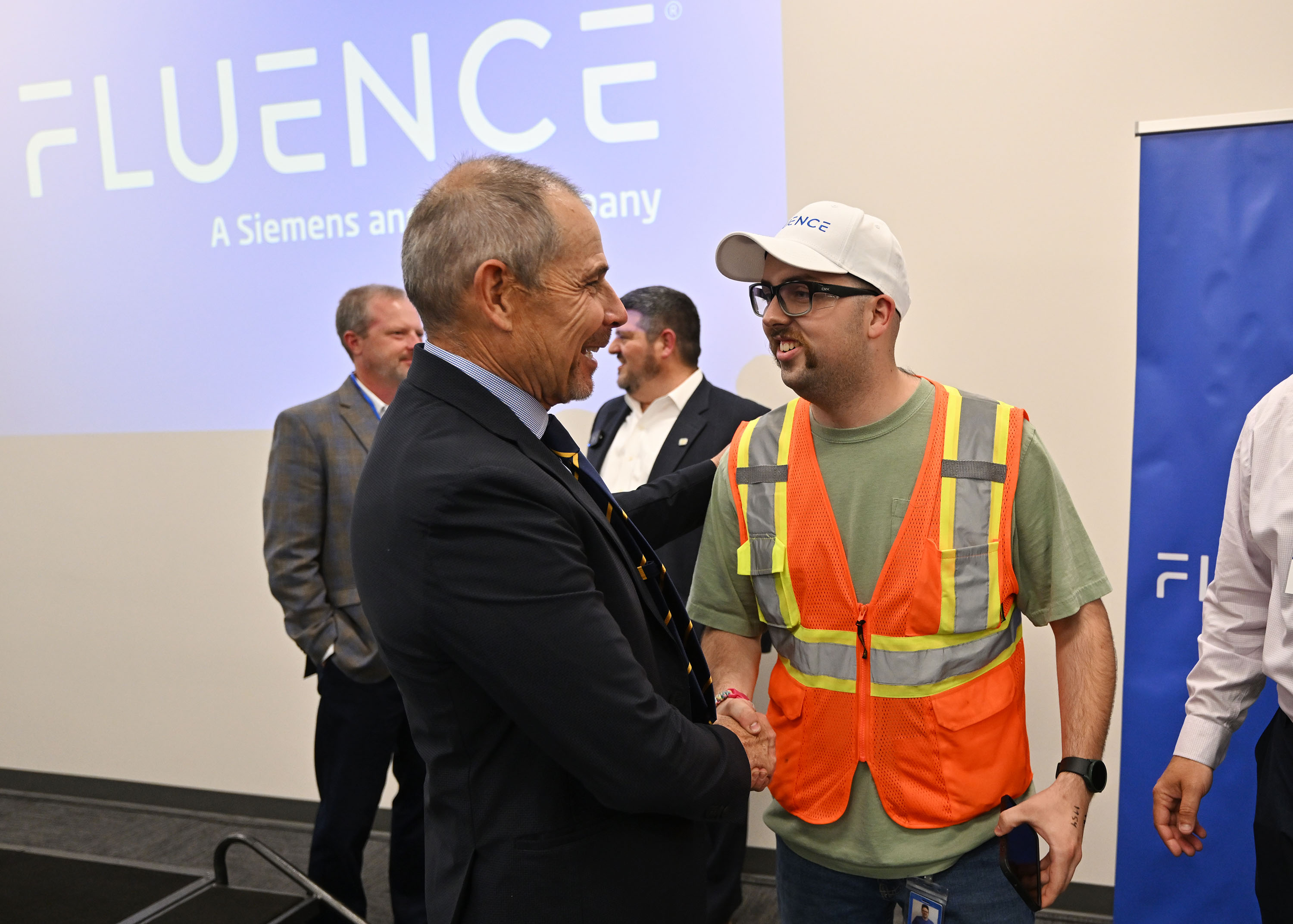 Utah Sen. John Curtis shakes hands with Logan Williams, a production group lead at Fluence, after a short press conference and tour of Fluence Energy, Inc. in Erda, Tooele County, on Tuesday.