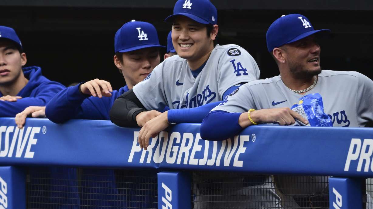 Los Angeles Dodgers' Shohei Ohtani smiles in the dugout during the first inning of a baseball game against the Cleveland Guardians, Tuesday, May 27, 2025, in Cleveland.