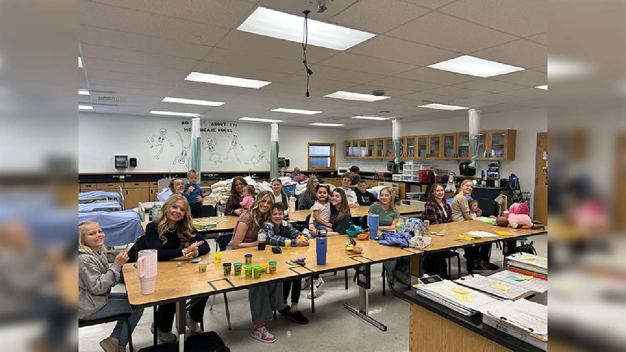 Snake River High School’s CNA class, which consists mostly of seniors, smile for a picture with their kid they brought to school for their senior prank in Blackfoot, Idaho.