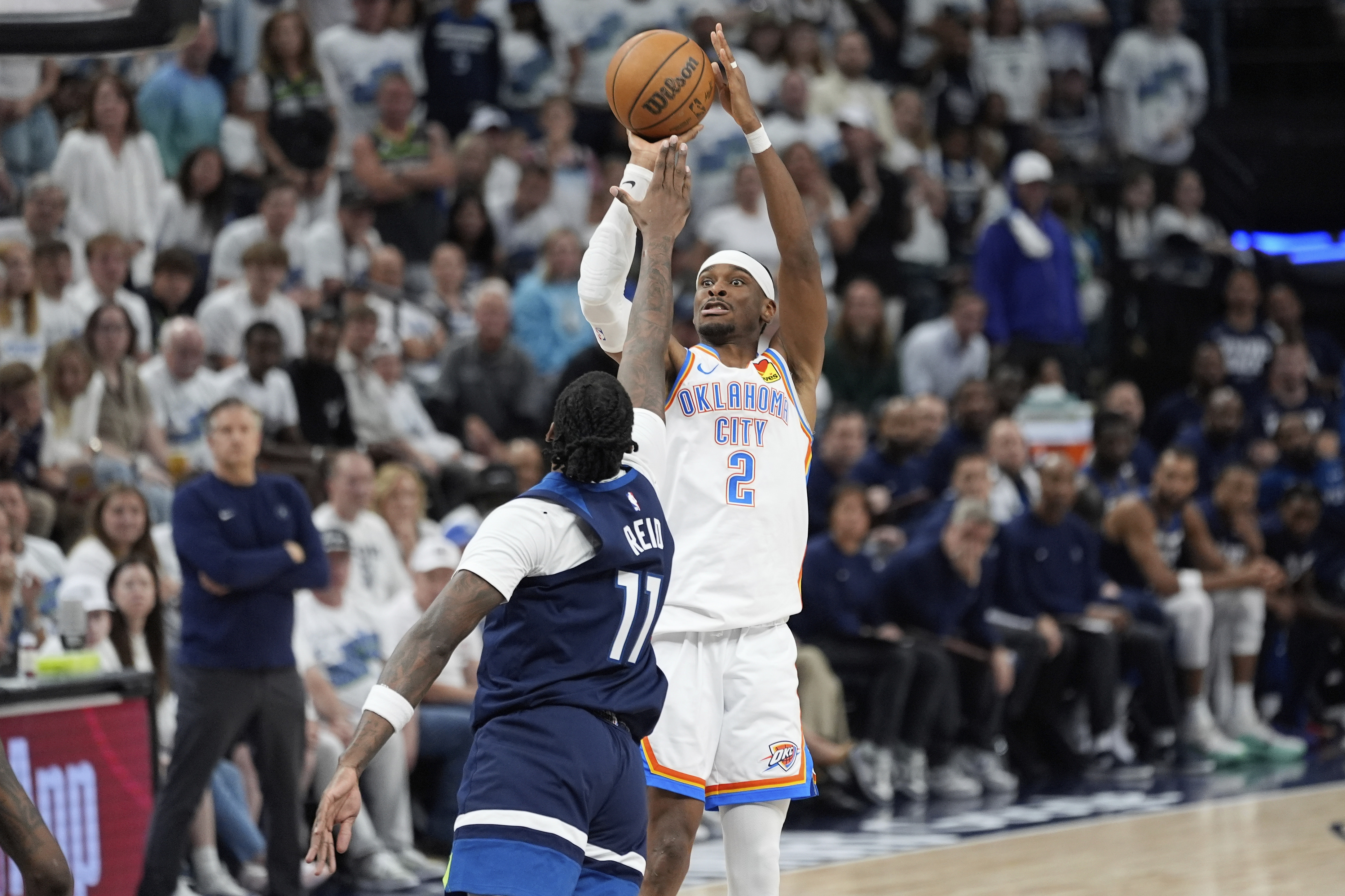 Oklahoma City Thunder guard Shai Gilgeous-Alexander (2) shoots against Minnesota Timberwolves center Naz Reid during the second half of Game 4 of the Western Conference finals of the NBA basketball playoffs Monday, May 26, 2025, in Minneapolis. 