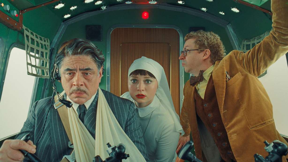 This image released by Focus Features shows Benicio del Toro, left, Mia Threapleton, center, and Michael Cera in a scene from "The Phoenician Scheme."