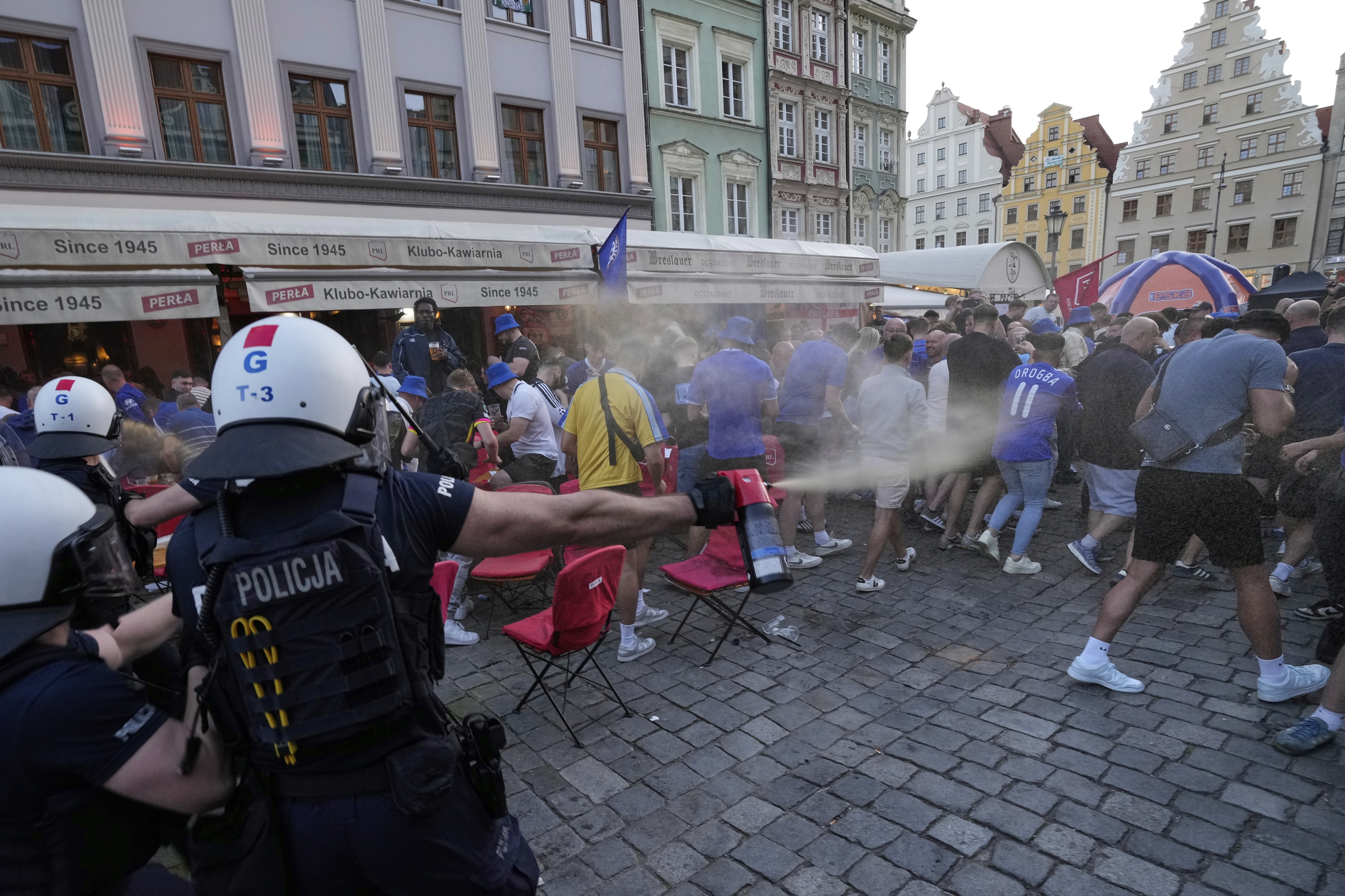 Police spray tear gas at Chelsea fans ahead of the Europa Conference League final soccer match between Real Betis and Chelsea in Wroclaw, Poland, Tuesday, May 27, 2025. 