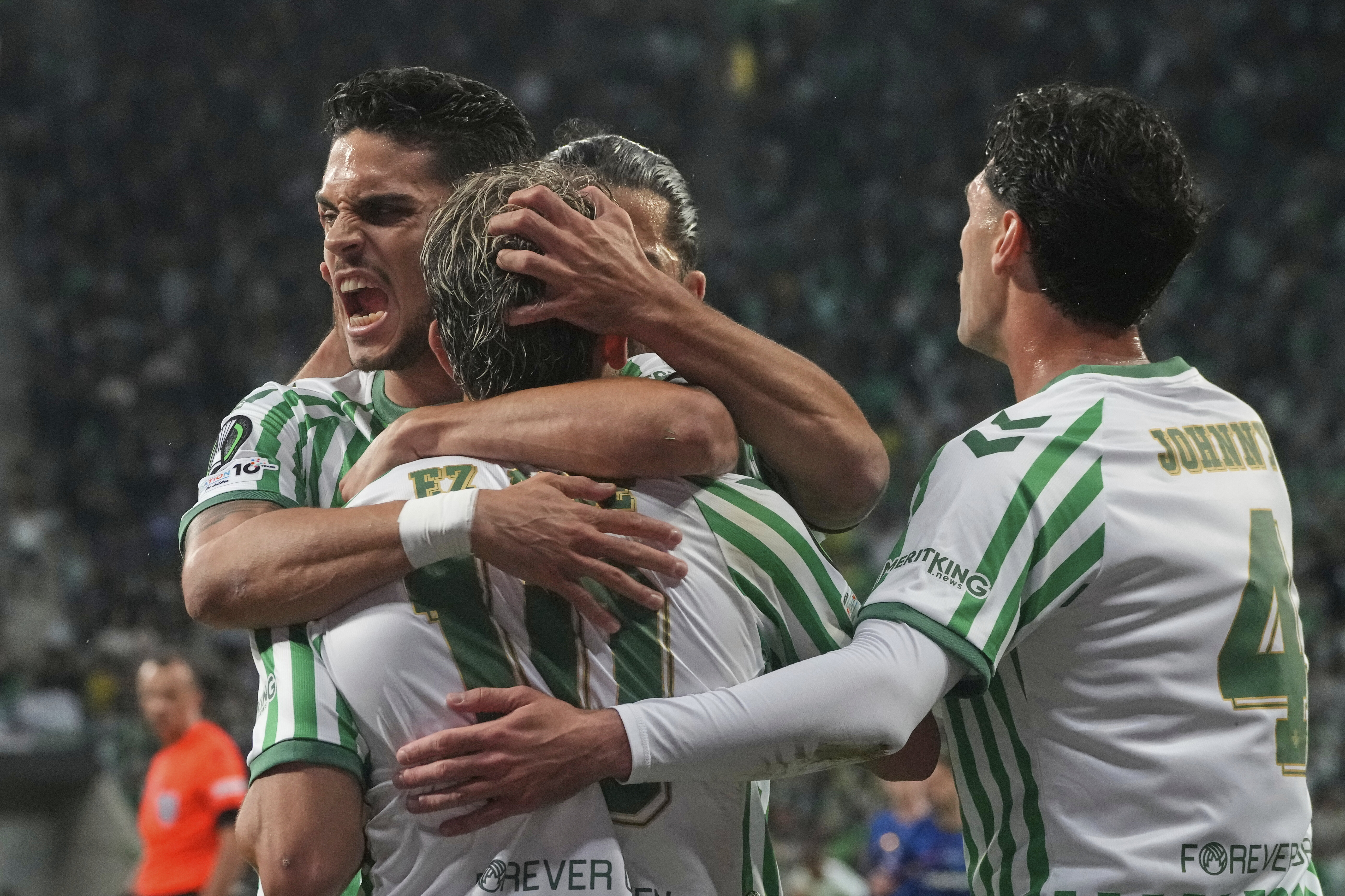Real Betis players celebrate after Betis' Abde Ezzalzouli, centre, scored his side's opening goal during the Europa Conference League final soccer match between Real Betis and Chelsea in Wroclaw, Poland, Wednesday, May 28, 2025. 