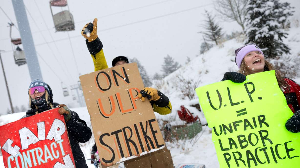 Park City Professional Ski Patrol Association members Alina Waldo, Cameron Bellinger and Hanna Morrow acknowledge the honking horns of passing motorists while picketing in Park City on Dec. 27, 2024.