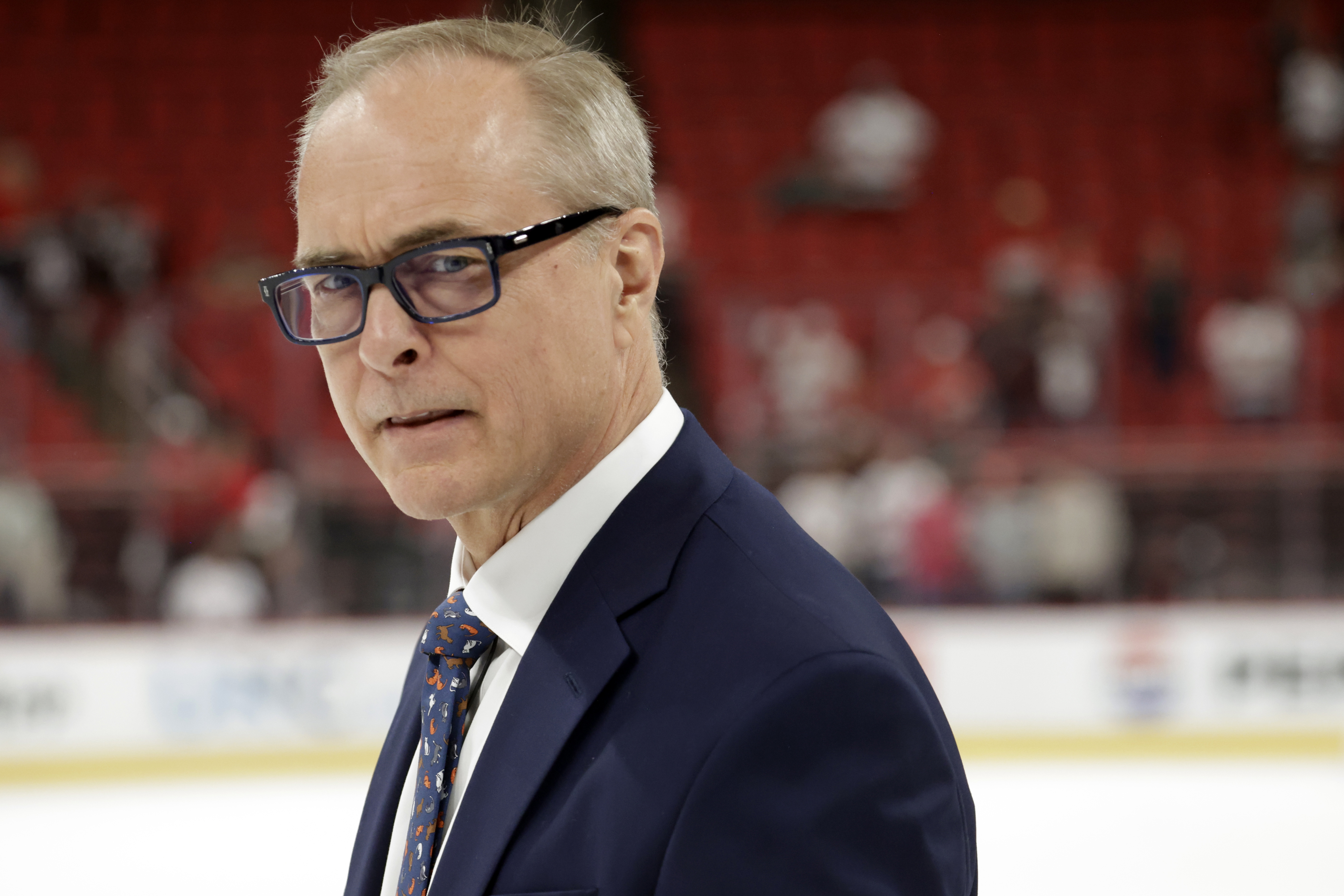 Florida Panthers head coach Paul Maurice watches as the players celebrate at the conclusion of Game 5 of the NHL hockey Stanley Cup Eastern Conference finals Wednesday, May 28, 2025, in Raleigh, N.C. The Panthers team defeated the Carolina Hurricanes to advance to the Stanley Cup finals. 