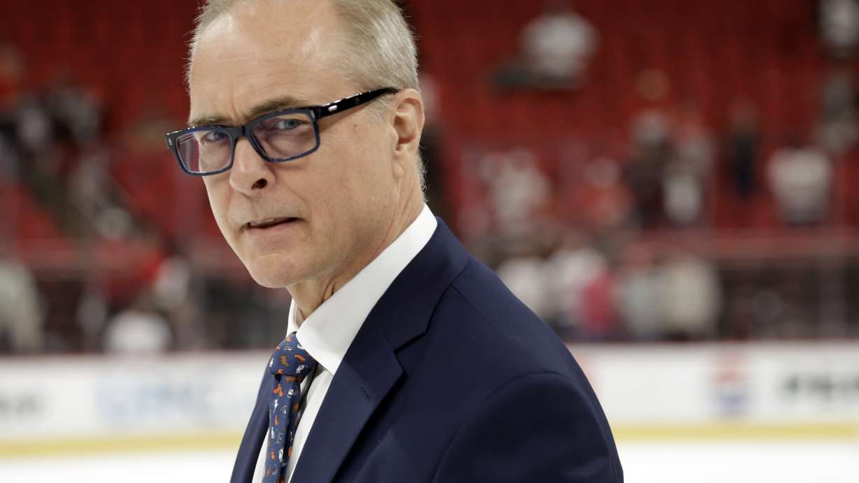 Florida Panthers head coach Paul Maurice watches as the players celebrate at the conclusion of Game 5 of the NHL hockey Stanley Cup Eastern Conference finals Wednesday, May 28, 2025, in Raleigh, N.C. The Panthers team defeated the Carolina Hurricanes to advance to the Stanley Cup finals.