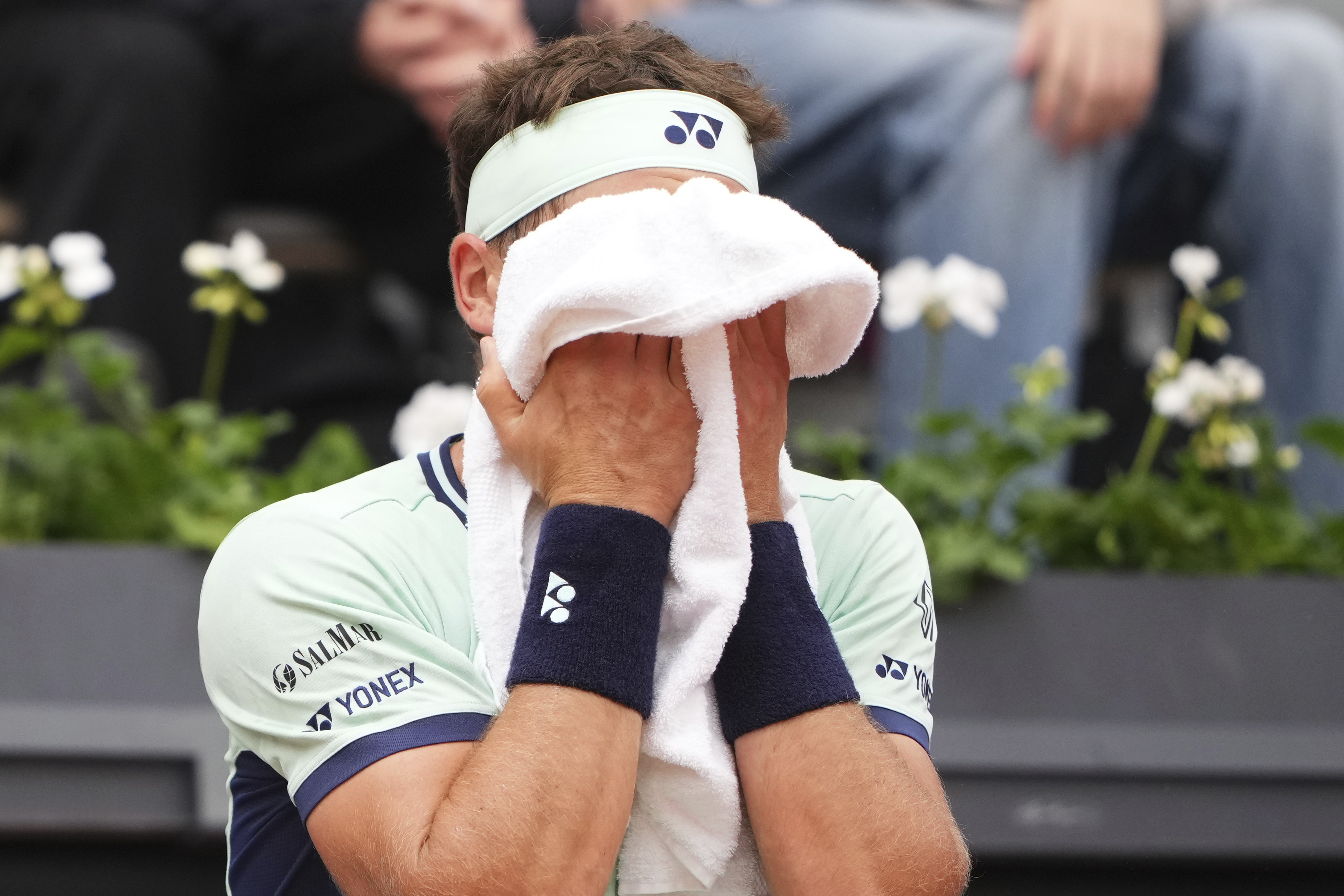 Norway's Casper Ruud wipes his face as he plays Portugal's Nuno Borges during their second round match of the French Tennis Open, at the Roland-Garros stadium, in Paris, Wednesday, May 28, 2025. 