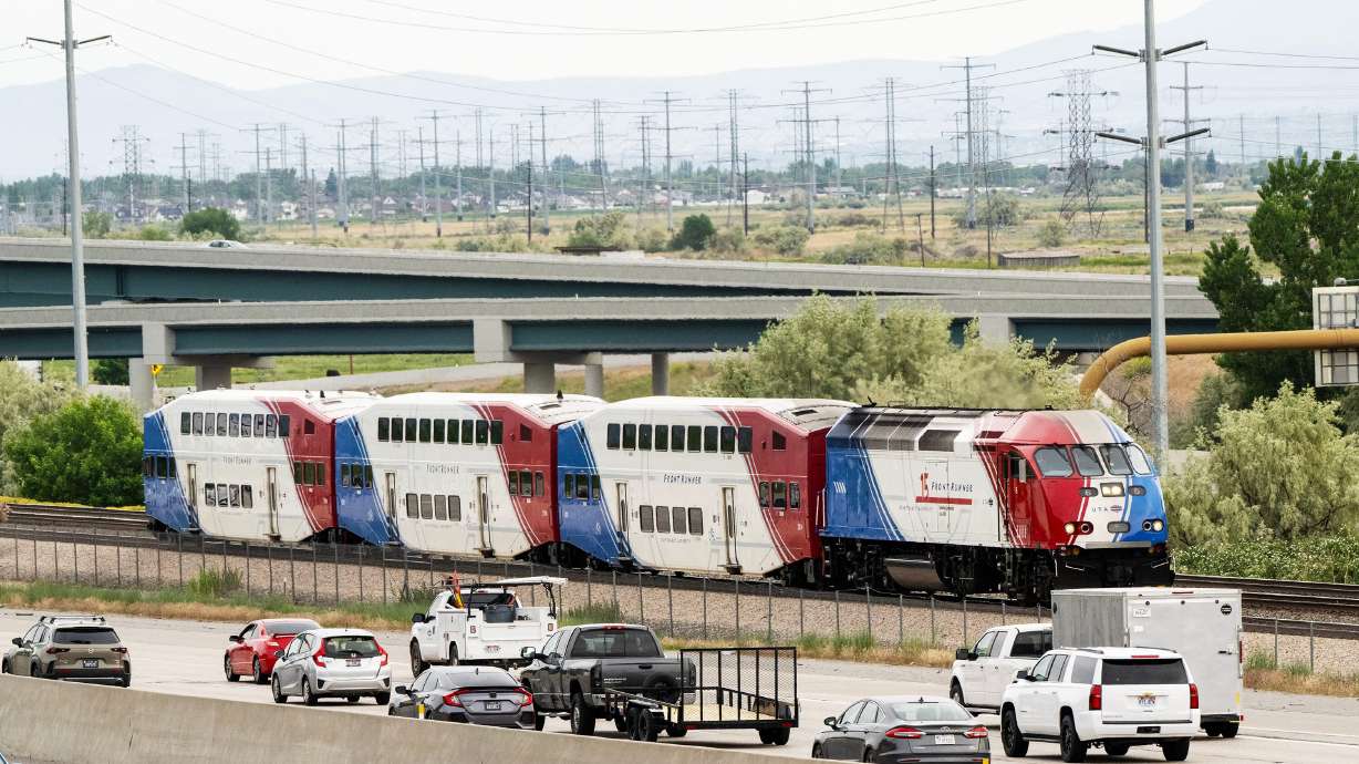 A FrontRunner train runs next to the traffic on I-15 and Legacy Parkway in North Bountiful and Farmington Station area on Wednesday.