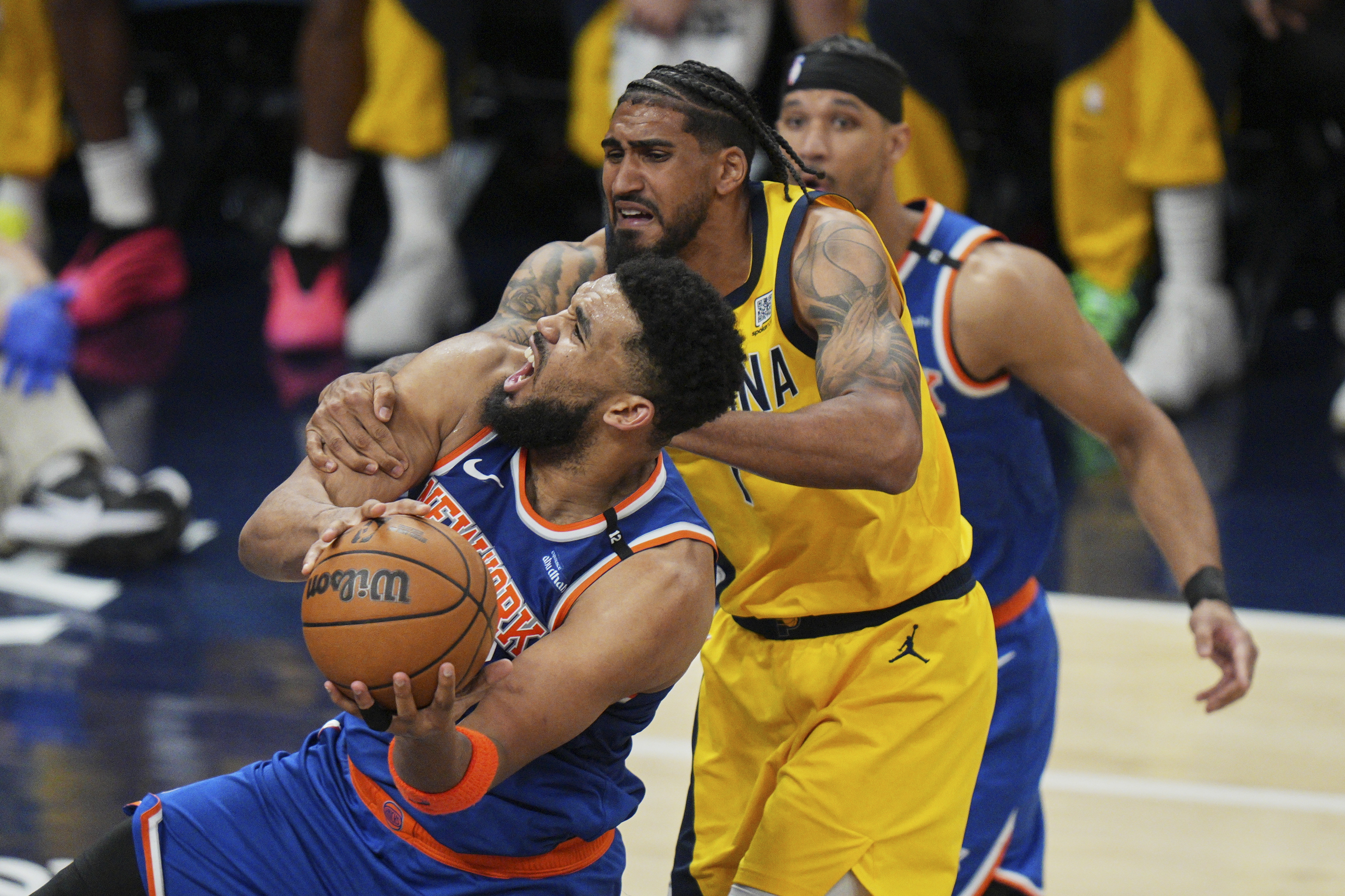 New York Knicks center Karl-Anthony Towns, left, shoots the ball past Indiana Pacers forward Obi Toppin, right, during the second half of Game 4 of the Eastern Conference finals of the NBA basketball playoffs in Indianapolis, Tuesday, May 27, 2025. 