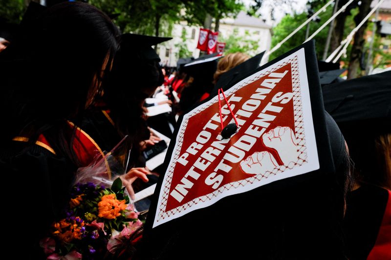 A graduate's cap decoration supporting international students during Harvard commencement Thursday. A federal judge said she would extend an order blocking the Trump administration from revoking the university's ability to enroll international students.