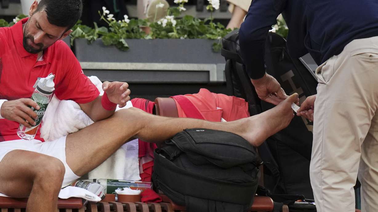 Serbia's Novak Djokovic receives medical assistance during his second round match of the French Tennis Open against France's Corentin Moutet, at the Roland-Garros stadium, in Paris, Thursday, May 29, 2025.