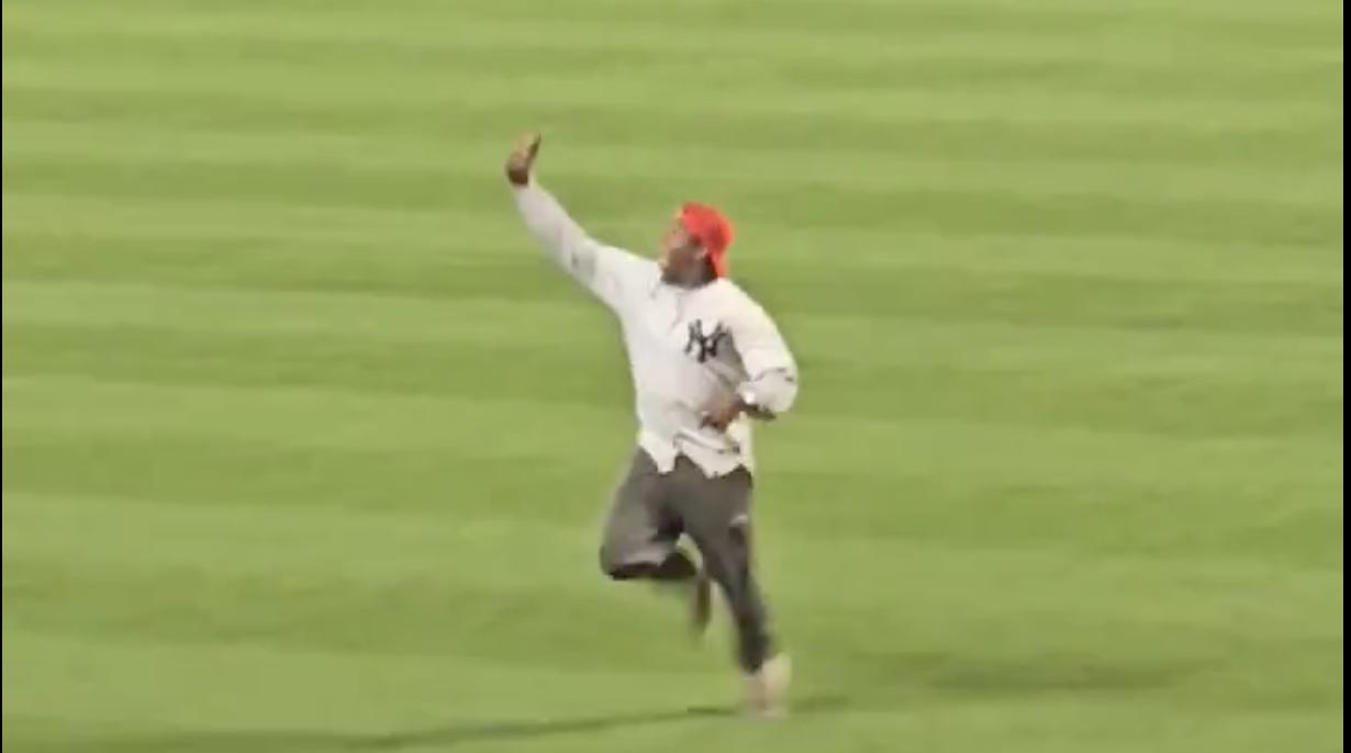 Yankees fan run onto field during game.