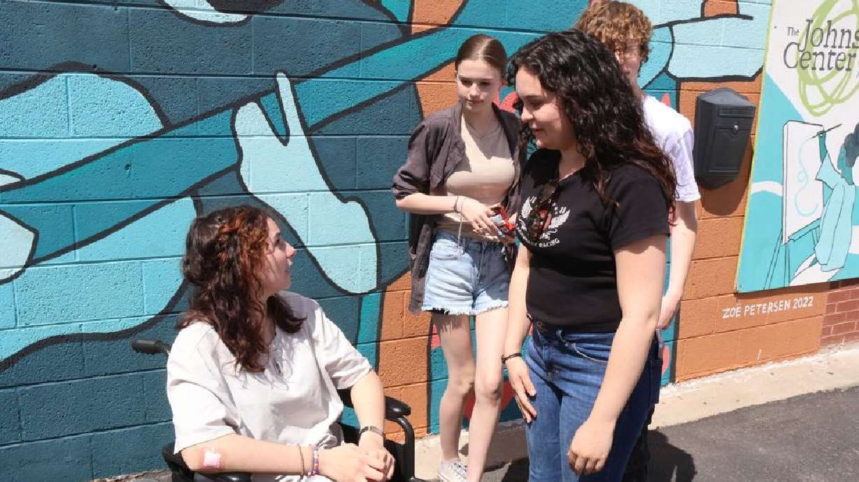 Trinity Dorris talks with friends during a welcome-home gathering in Cedar City, May 3. It came just weeks after Dorris was critically injured after being struck by a vehicle on Interstate 15.
