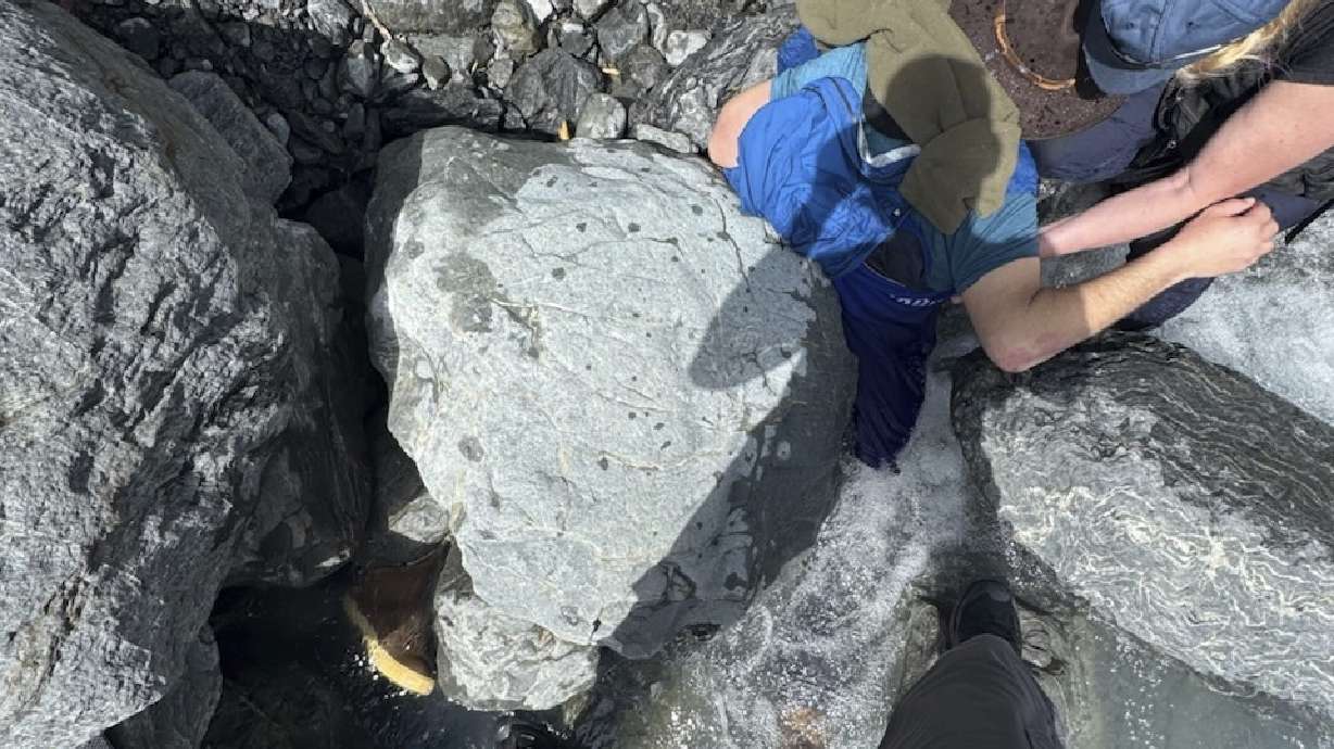 Kell Morris, upper right in a brown hat, was trapped under a 700-pound rock near Seward, Alaska, on May 24.