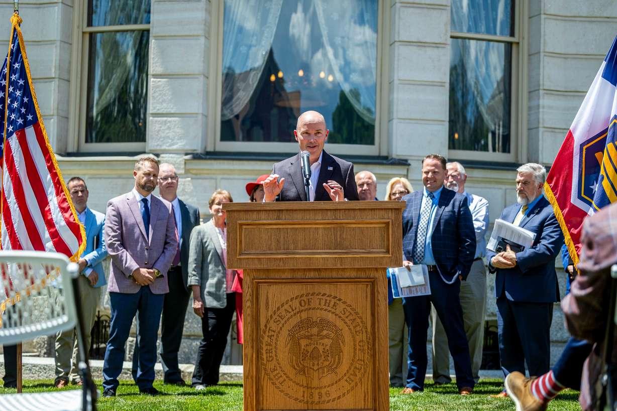 Flanked by mayors of various Utah cities, Utah Gov. Spencer Cox speaks during a press conference as part of a housing summit held at the Governor's Mansion in Salt Lake City on Thursday.