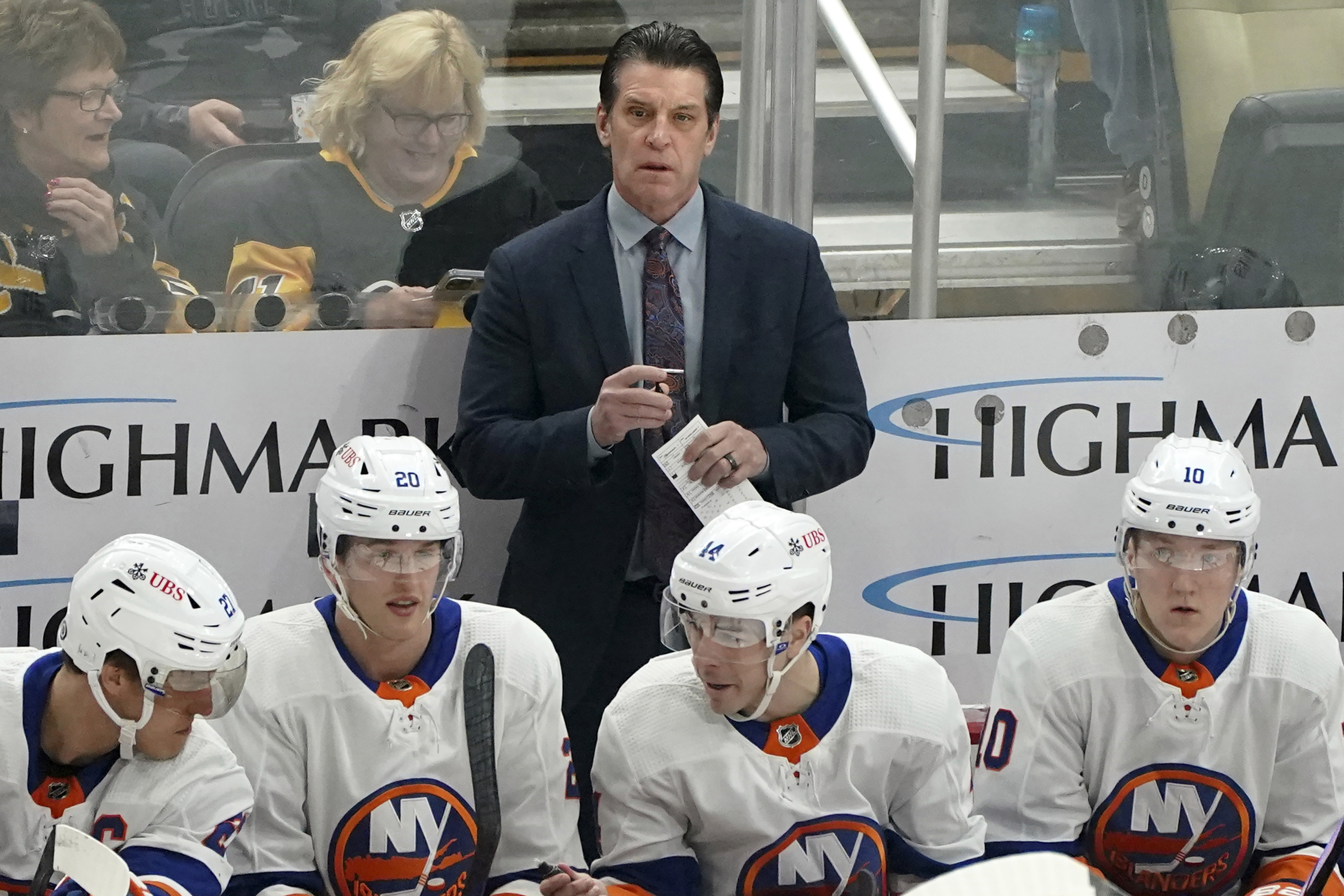 FILE - New York Islanders head coach Lane Lambert, center top, stands behind the bench during the first period of an NHL hockey game against the Pittsburgh Penguins, Sunday, Dec. 31, 2023, in Pittsburgh. 