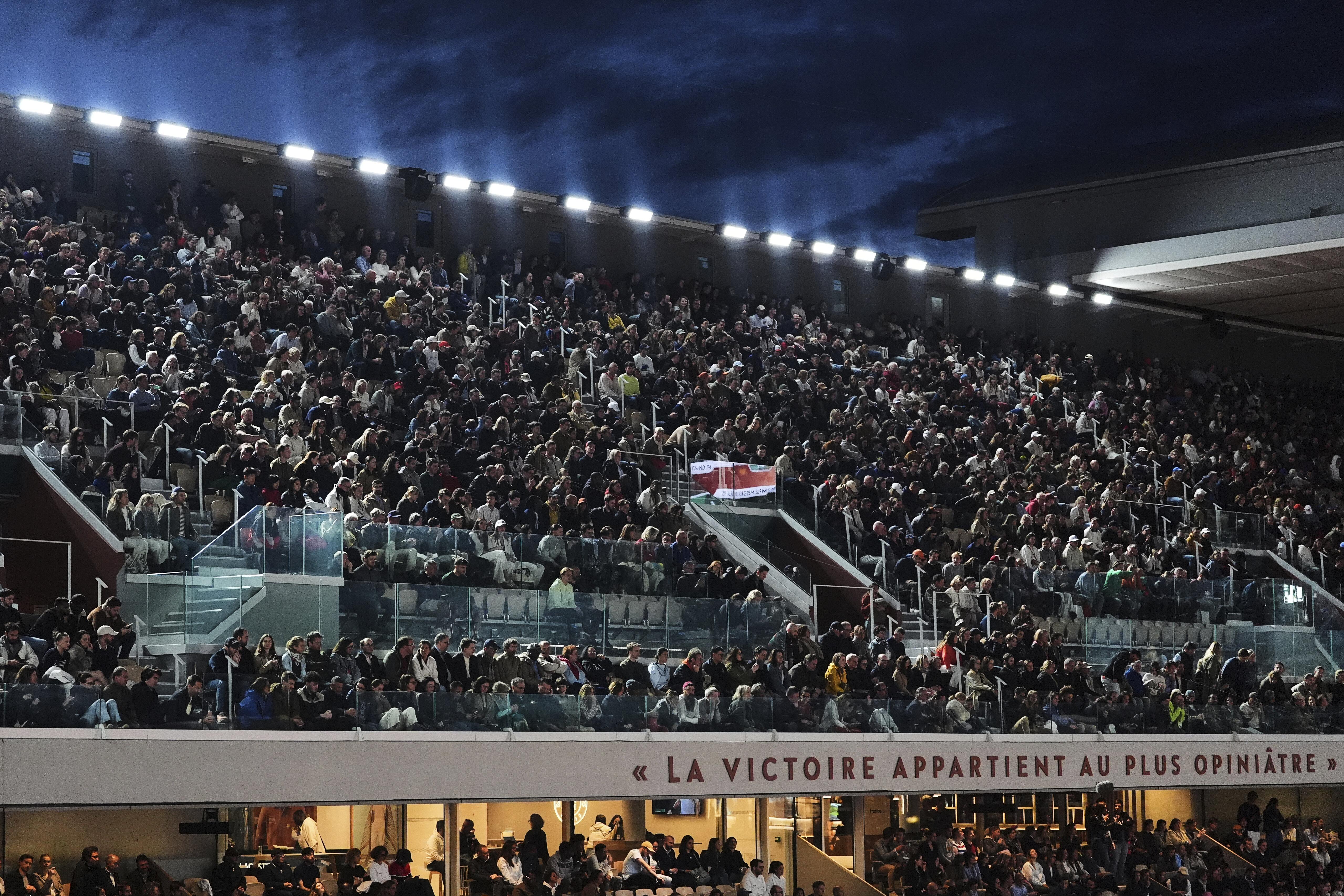 Fans watch on Court Philippe-Chatrier during a first-round match between Italy's Jannik Sinner and France's Arthur Rinderknech in the French Tennis Open at the Roland-Garros stadium in Paris, Monday, May 26, 2025. 