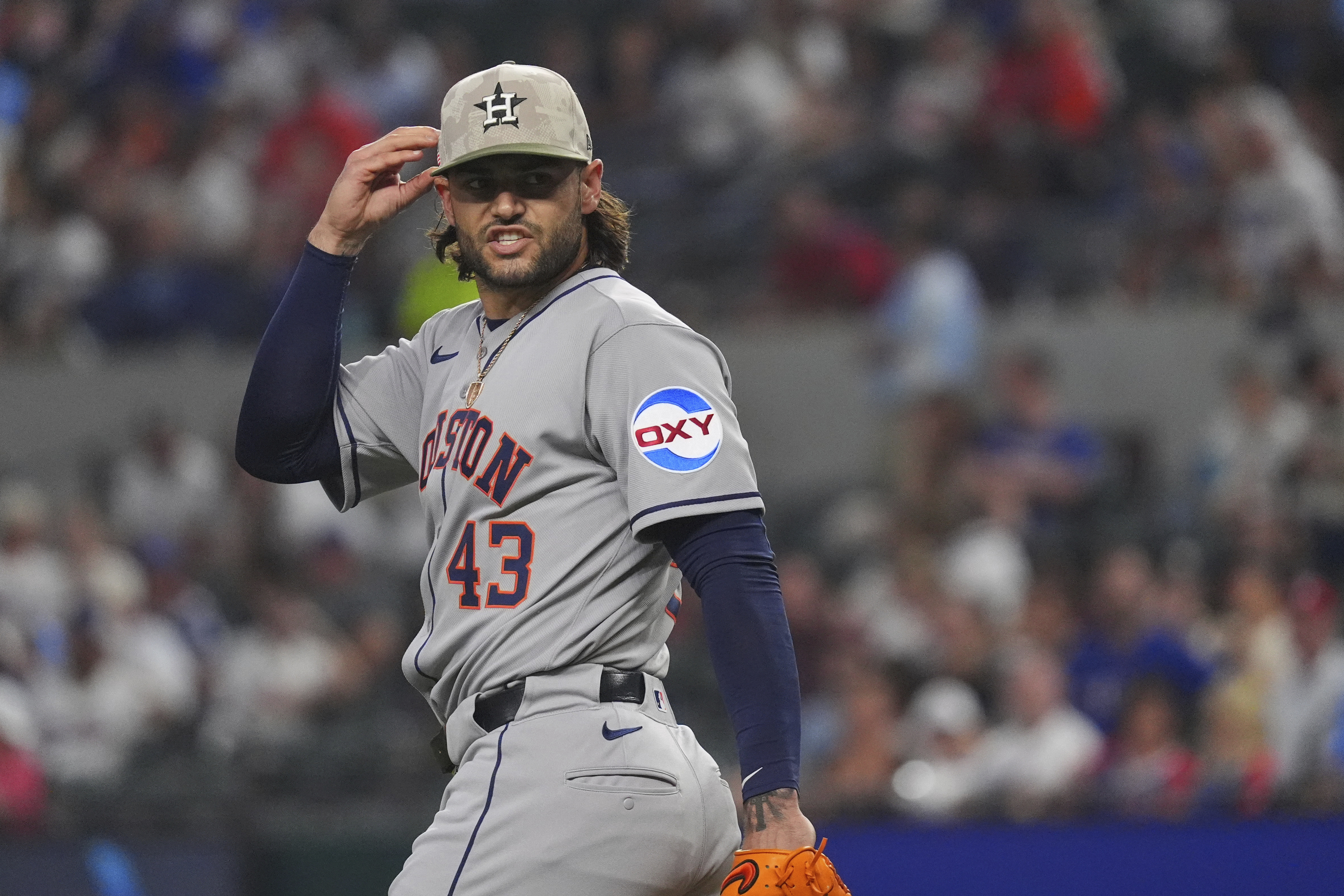 Houston Astros starting pitcher Lance McCullers Jr. reacts after a throw during the first inning of a baseball game against the Texas Rangers, Friday, May 16, 2025, in Arlington, Texas. 