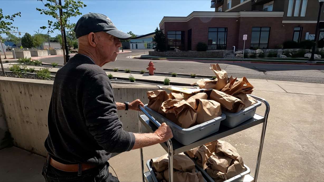 Maury Kettell takes sack lunches to a truck to make deliveries Thursday in Clearfield. Meals on Wheels in Davis County faces a shortage of good volunteers as need increases.