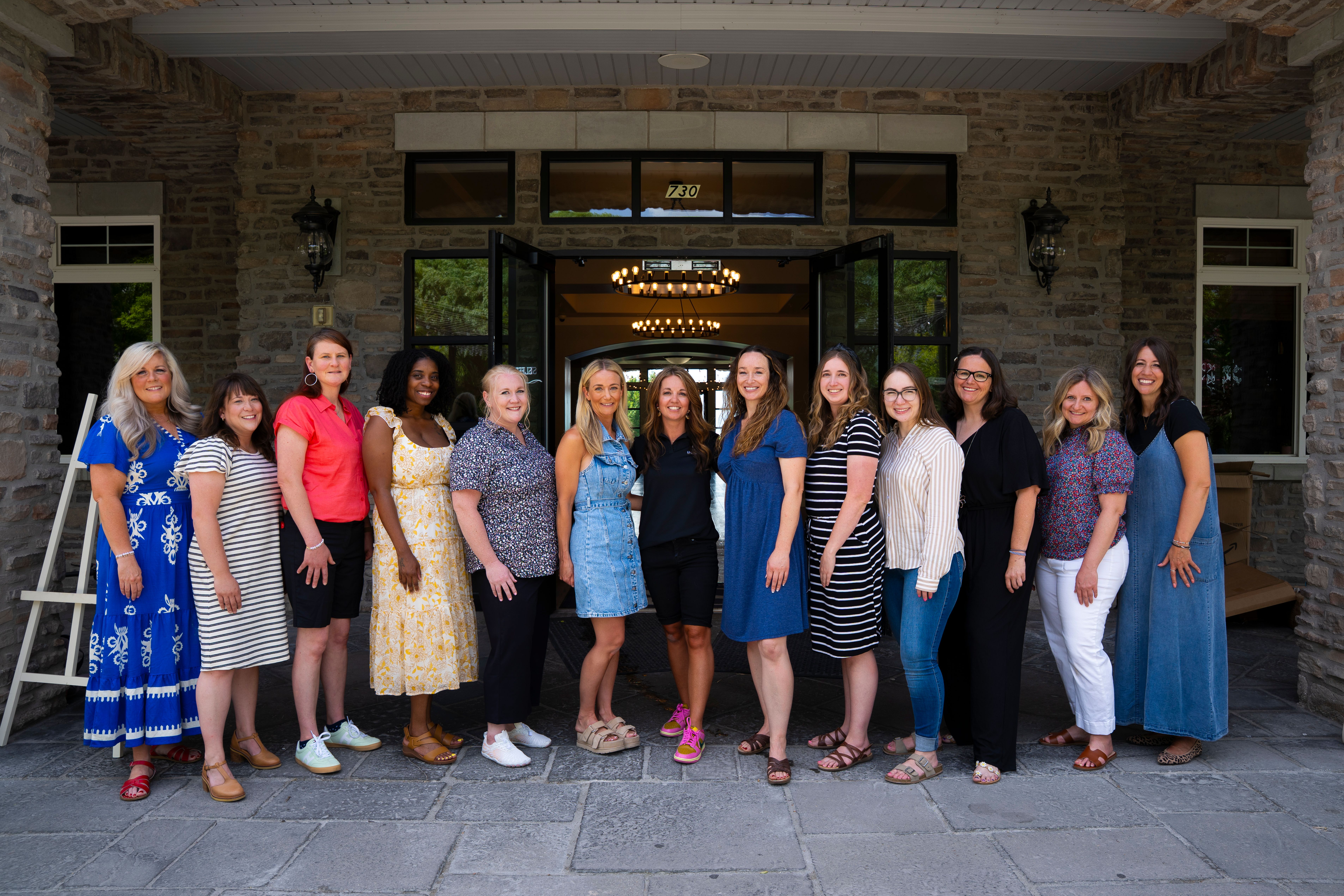 Thirteen of 15 women who received scholarship money from the Live Your Dream organization on Thursday. They can use the funds to further their higher education and support their families.