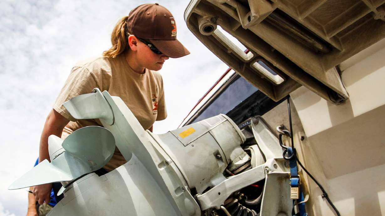 Hannah Shramm inspects David Black's boat for quagga mussels at the Daniels Port of Entry checkpoint near Heber City on July 1, 2016. Quagga mussels entered Utah's lakes in 2007.