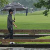 Nick Taylor makes it look easy in the rain and shares the lead at Memorial
